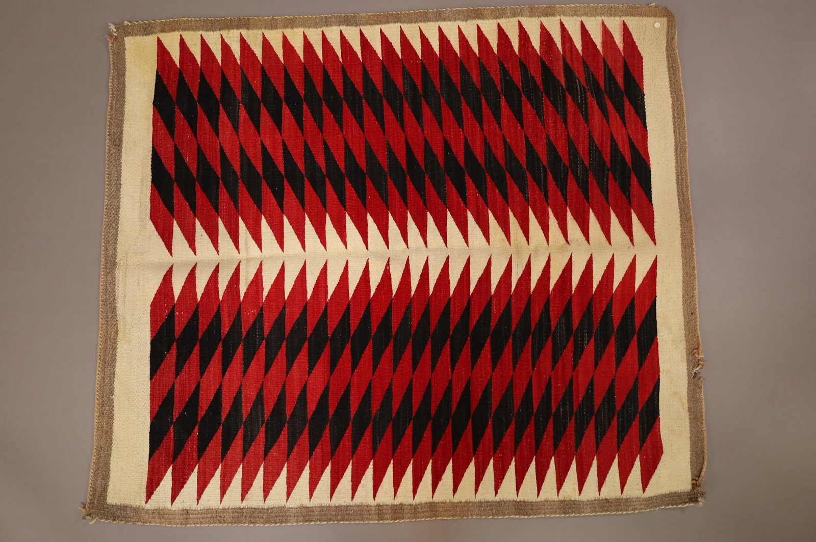 NATIVE AMERICAN NAVAJO RUG: 51" x 44" HANDMADE NAVAJO EYE DAZZLER WEAVING. EDGE WEAR, STAIN.