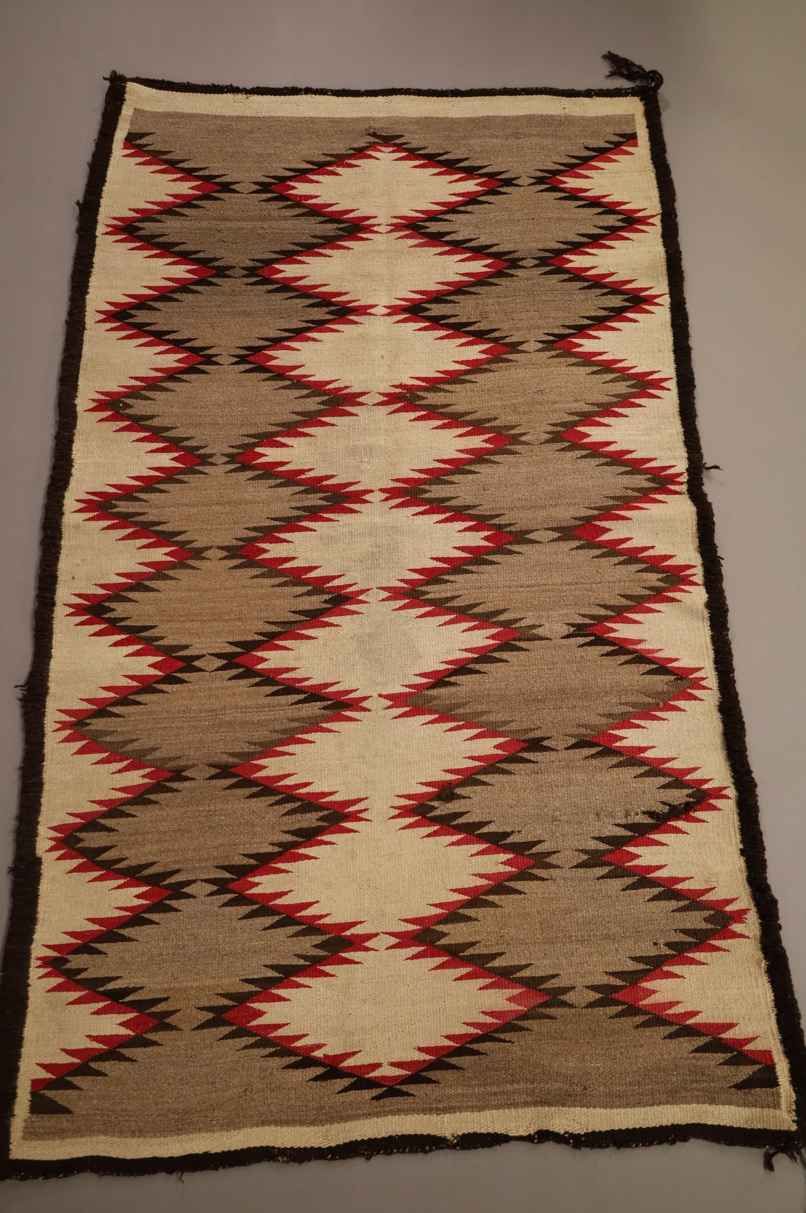 NATIVE AMERICAN NAVAJO RUG: 70" x 43" HANDMADE NAVAJO WEAVING, EDGE WEAR. BLEEDING, NEEDS CLEANED.