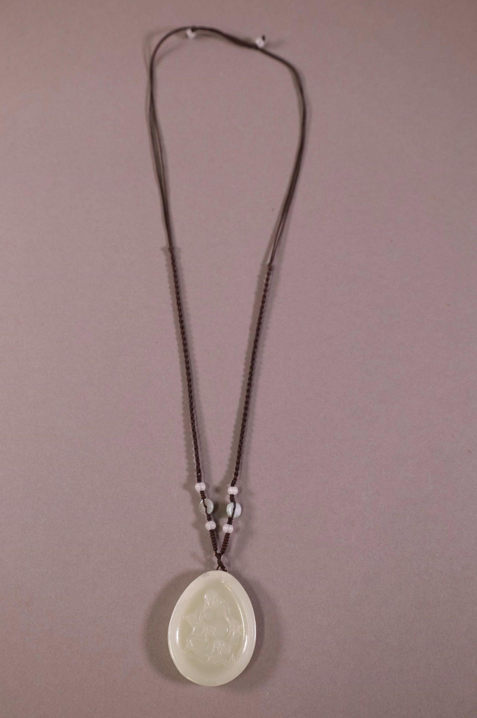CHINESE JADEITE PENDANT: JADEITE PENDANT WITH BUDDHA. 2" DIAMETER