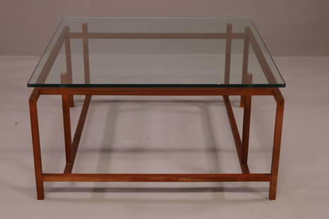 HENNING NORGAARD FOR KOMFORT COFFEE TABLE: MID CENTURY MODERN HENNING NORGAARD FOR KOMFORT TEAK FLOATING GLASS TOP COFFEE TABLE. MARKED ON UNDERSIDE. MINOR WEAR TO FINISH. CRACKS TO TWO LEGS. 31 1/2" x 31 1/2" x 16 1/2" H, THIS ITEM EXCEEDS SI