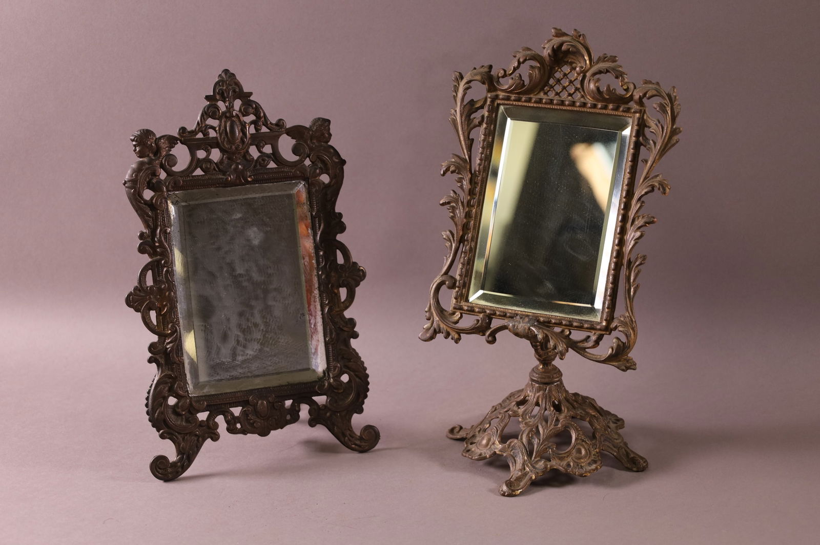 2 ANTIQUE CAST METAL TABLE MIRRORS: ANTIQUE FRAMED TABLE MIRRORS, EASEL BACK & FOOTED MIRROR. 11" - 12 1/2" H