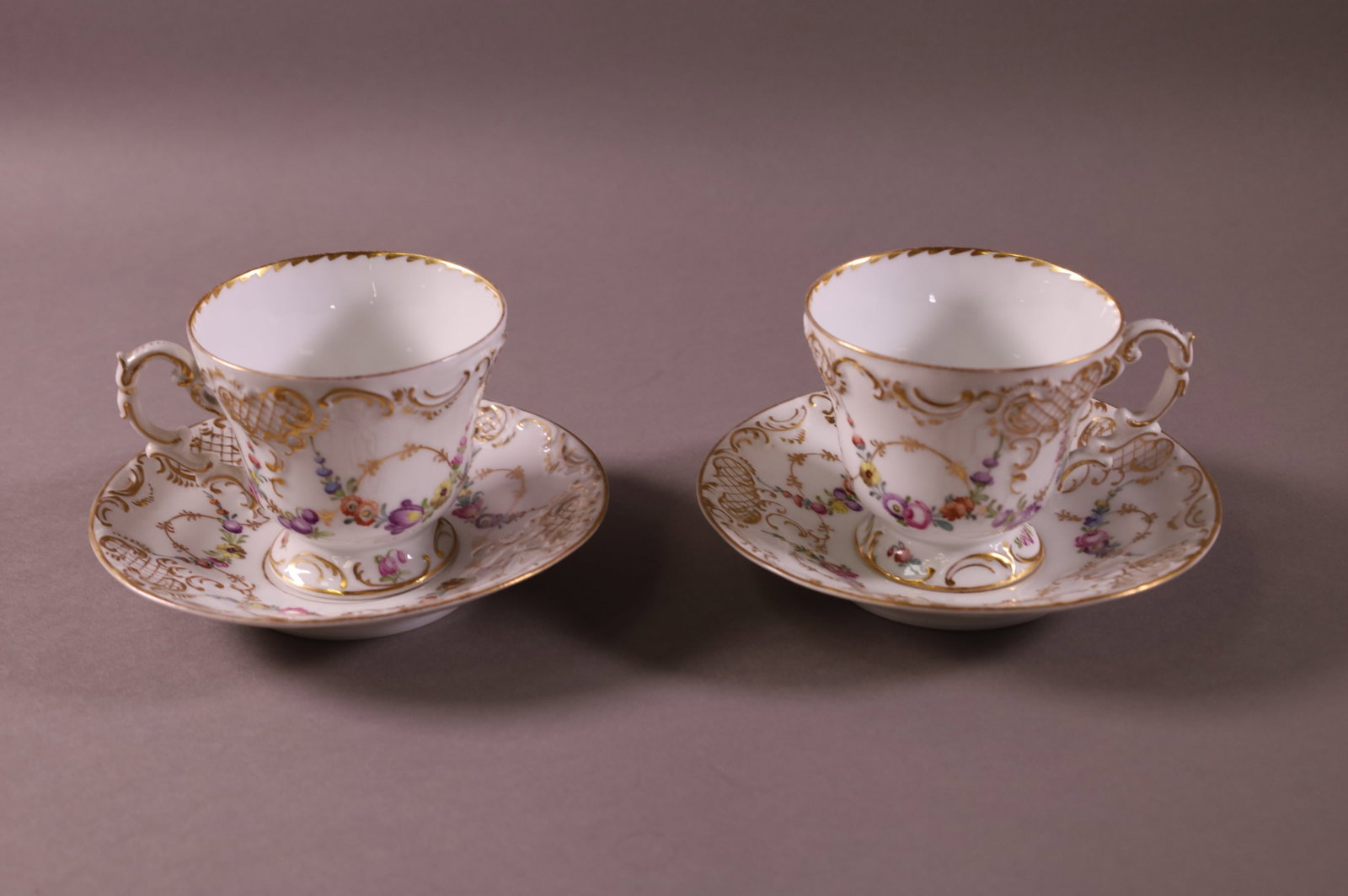 PAIR OF MEISSEN CUPS AND SAUCERS: CROSS SWORD MARK, FLORAL PATTERN. 6" DIAM.