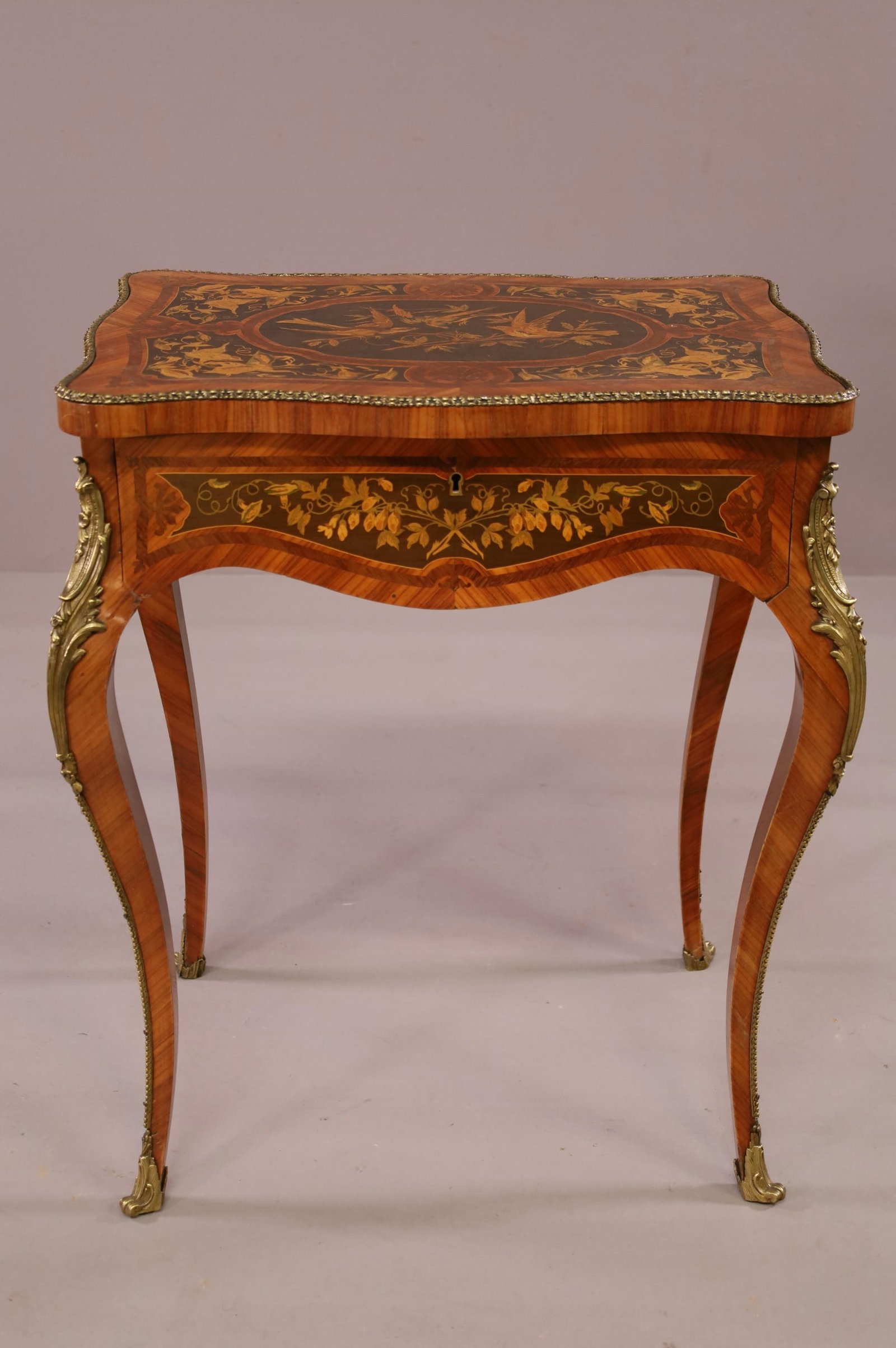 INLAID FRENCH STYLE FLIP TOP VANITY: POUDREUSE. MIRRORED INTERIOR. INLAID. BRASS MOUNTED ORMOLU. MINOR DAMAGE TO VENEER. 24" W x 17" D x 30" H. THIS ITEM EXCEEDS SIZE LIMITATIONS FOR IN HOUSE SHIPPING.