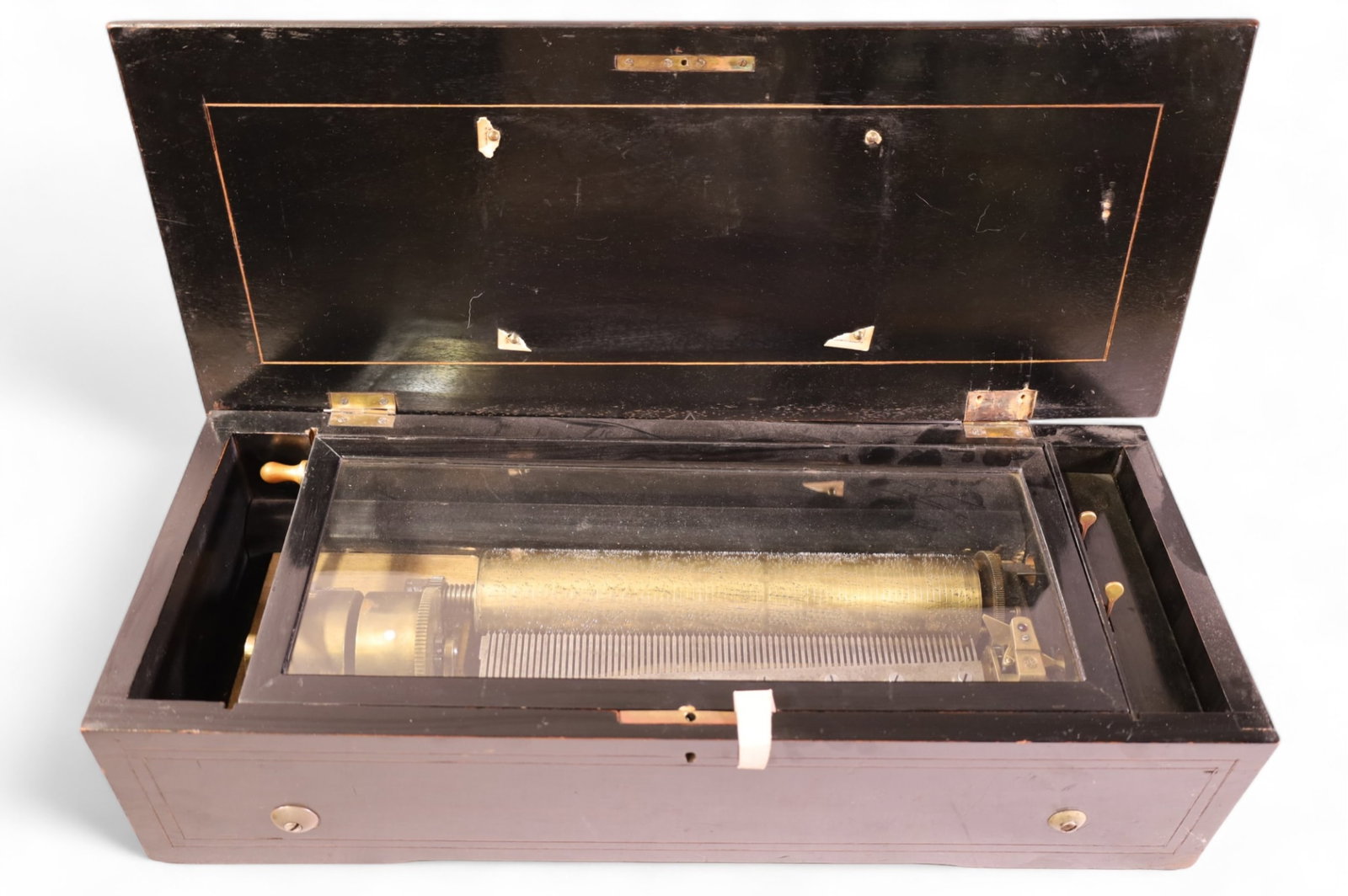 ANTIQUE MUSIC BOX: ROSEWOOD CASE MUSIC BOX, CYLINDER PLAYER, 10 SONGS. DAMAGE TO HINGE. INLAID TOP, MISISNG INLAY. WEAR TO CASE. BROKEN TOOTH. 22 1/2" L x 6" D