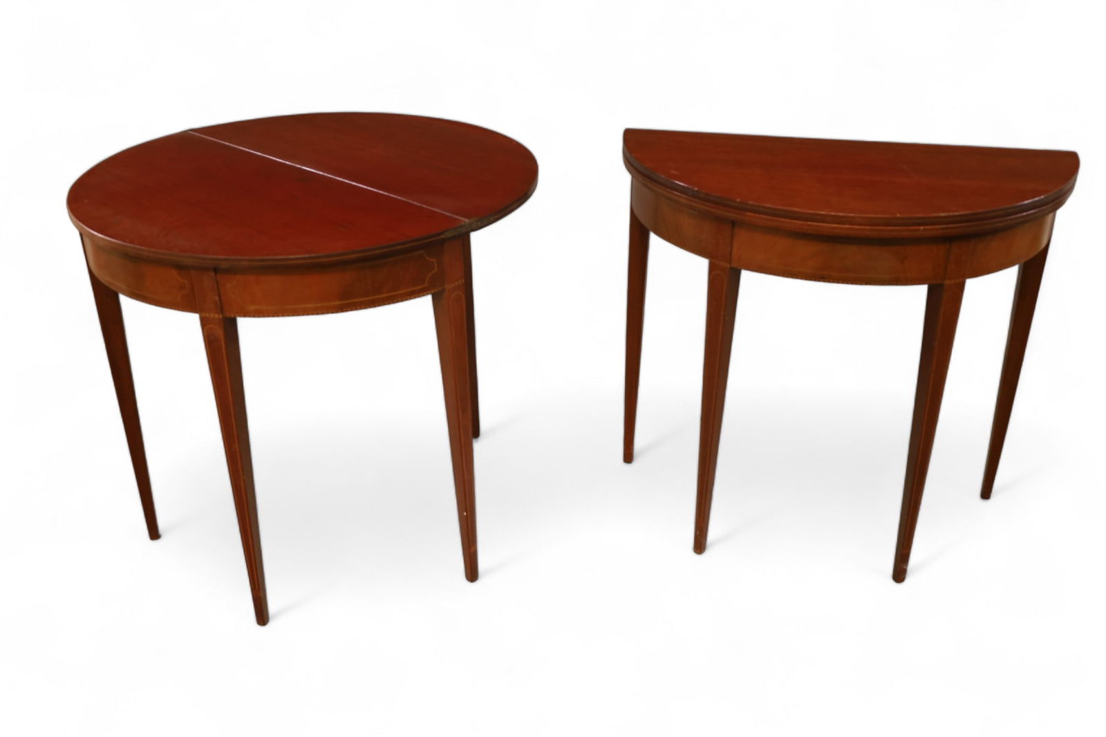 PAIR OF ANTIQUE FLIP TOP CONSOLE TABLES: PAIR OF INLAID HEPPLEWHITE DEMILUNE FLIP TOP GATE LEG CONSOLE TABLES. MINOR WEAR TO FINISH, LIGHT SURFACE SCRATCHES. 34" W x 17" D x 31" H. CLOSED. THIS ITEM EXCEEDS SIZE LIMITATIONS FOR IN HOUSE SHIP