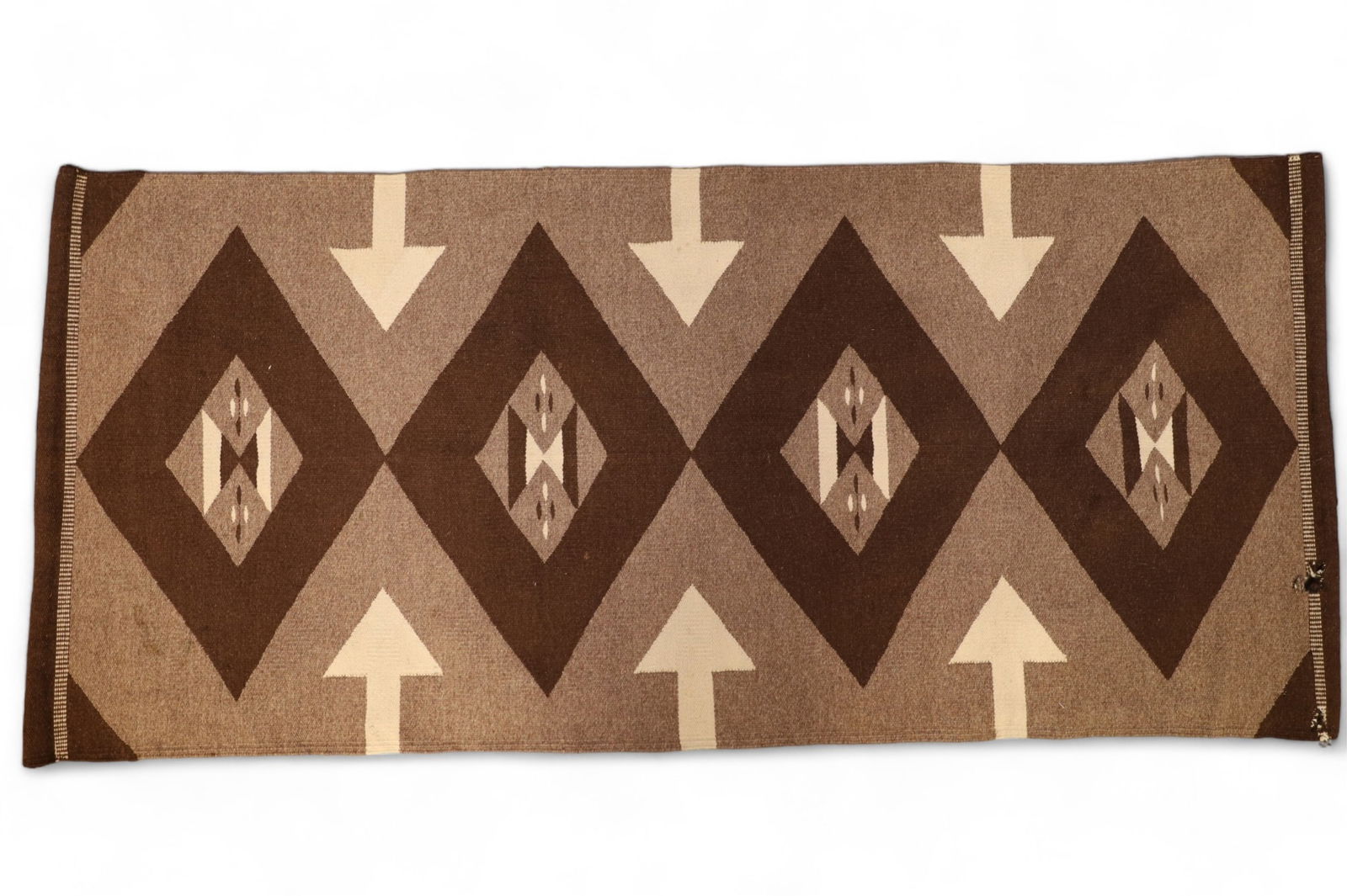 NAVAJO NATIVE AMERICAN RUG: ARROW PATTERN NATIVE AMERICAN RUG. ENDS HAVE BEEN SEWN OVER TO HANG. 2 HOLES ON EDGE. 63 X 28.