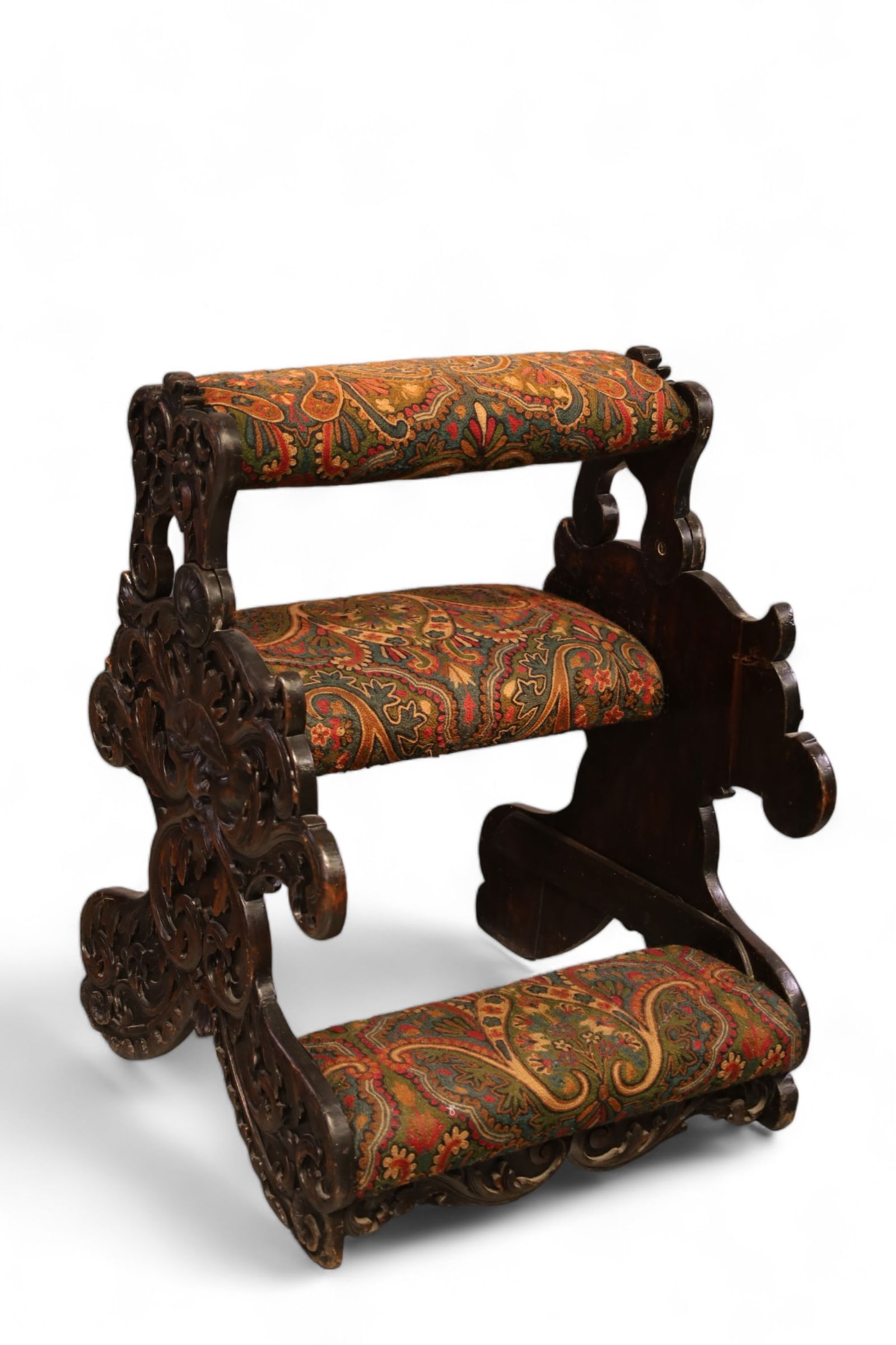ANTIQUE HIGHLY CARVED PRAYER CHAIR: HIGHLY CARVED FOLDING TOP PRAYER CHAIR HAS NORTH WIND FACE CARVED SIDES. REPAIRED TO FRONT SIDE AND REINFORMENT PIECES APPLIED TO INTERIOR SIDES. . 25 X 26 X 34. THIS ITEM EXCEEDS SIZE LIMITATIONS FOR