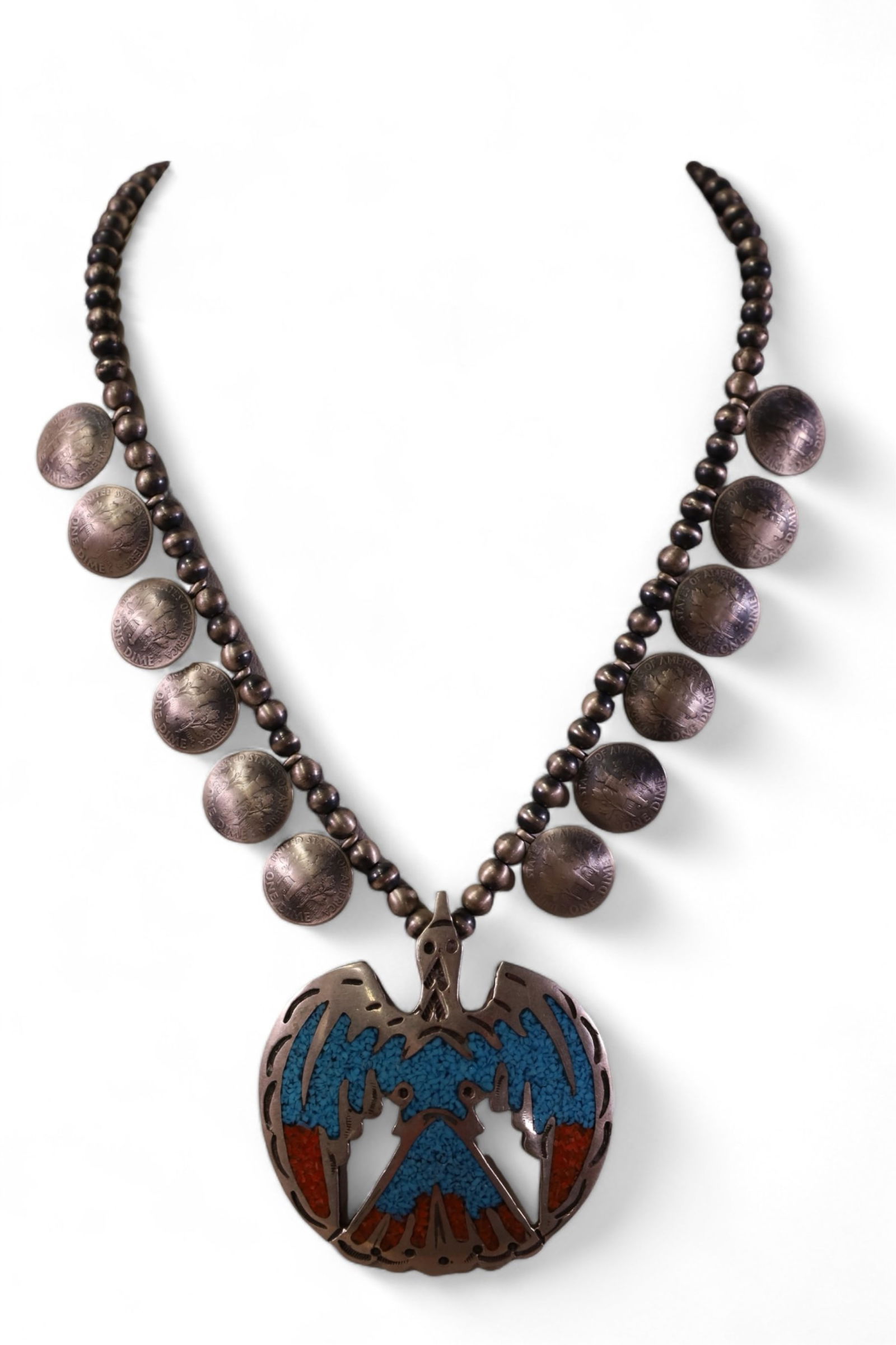 NATIVE AMERICAN SQUASH BLOSSOM NECKLACE: SQUASH BLOSSOM, SILVER, CORAL, & TURQUOISE. 12 SILVER DIME MEDALLIONS.