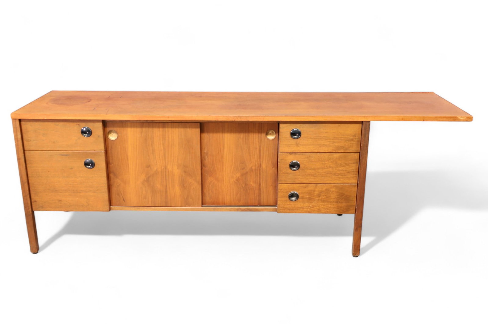 MID CENTURY MODERN CREDENZA (AS IS): MID CENTURY MODERN CREDENZA (AS IS) 5 DRAWERS & SLIDING DOORS, UNMARKED. FINISH LOSS, WATER DAMAGE. MISSING HARDWARE, VENEER IS LOOSE. 85" L x 22" D x 29" H. THIS ITEM EXCEEDS SIZE LIMITATIONS FOR IN 