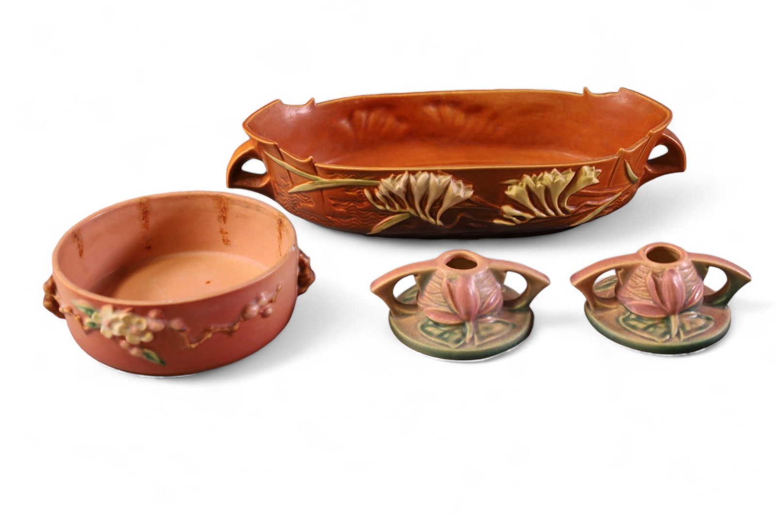 4 PIECES OF ROSEVILLE POTTERY: FREESIA 468-12 POTTERY CENTER BOWL, APPLE BLOSSOM LOW BOWL, WATER LILLY CANDLESTICKS. CHIP TO LOW BOWL.
