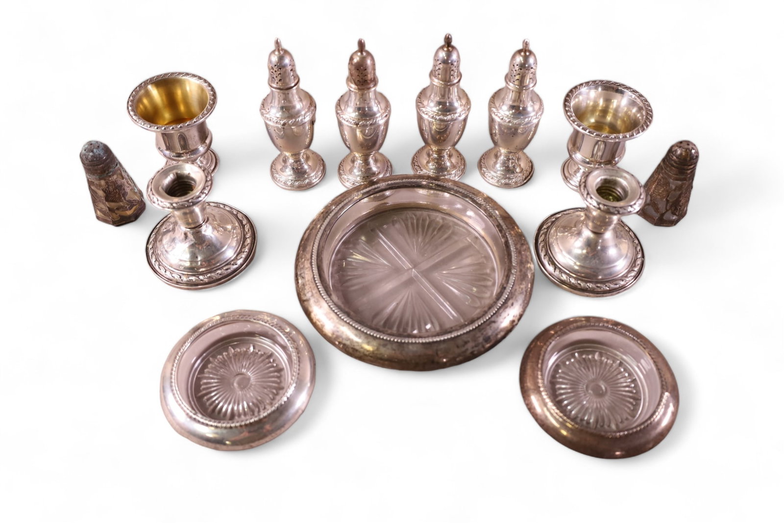 LOT OF MISC STERLING: WEIGHTED CANDELSTICKS, GLASS ASHTRAYS, SLAT & PEPPERS. 13 TOTAL PIECES.