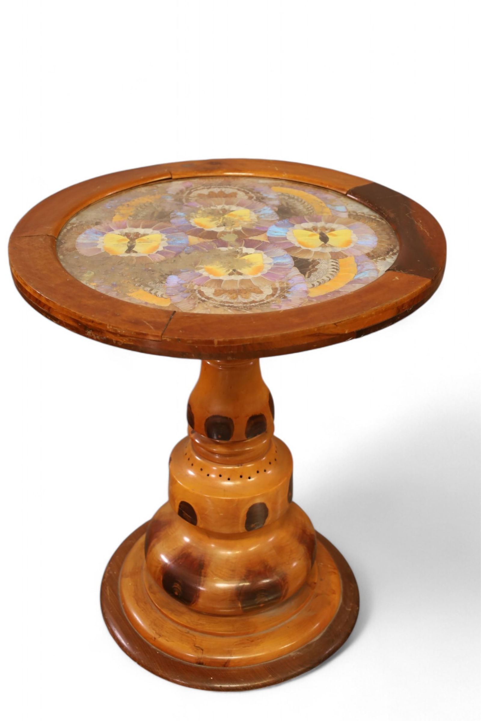 BUTTERFLY TABLE: SMALL ROUND TABLE WITH BUTTERFLY DECORATION, GLASS TOP. WEAR TO FINISH. DAMAGE TO BUTTERFLYS. 21" DIAM x 24" H. THIS ITEM EXCEEDS SIZE LIMITATIONS FOR IN HOUSE SHIPPING, IT MUST BE SHIPPED VIA 3rd PAR