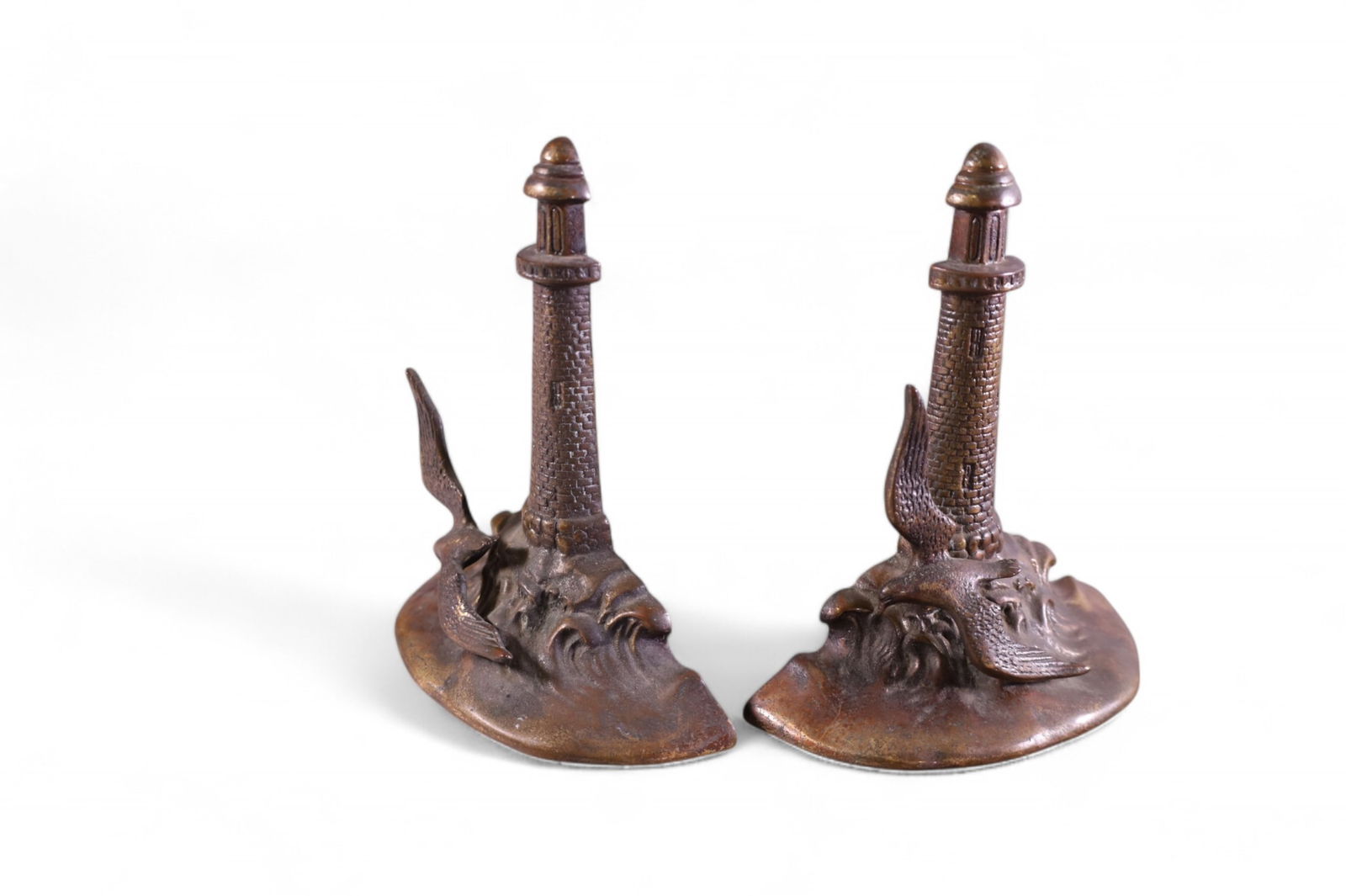 PAIR OF LIGHTHOUSE BOOKENDS: PAIR OF LIGHTHOUSE FORM BOOKENDS, MARKED GRAHAM BRONZE. 6" H.
