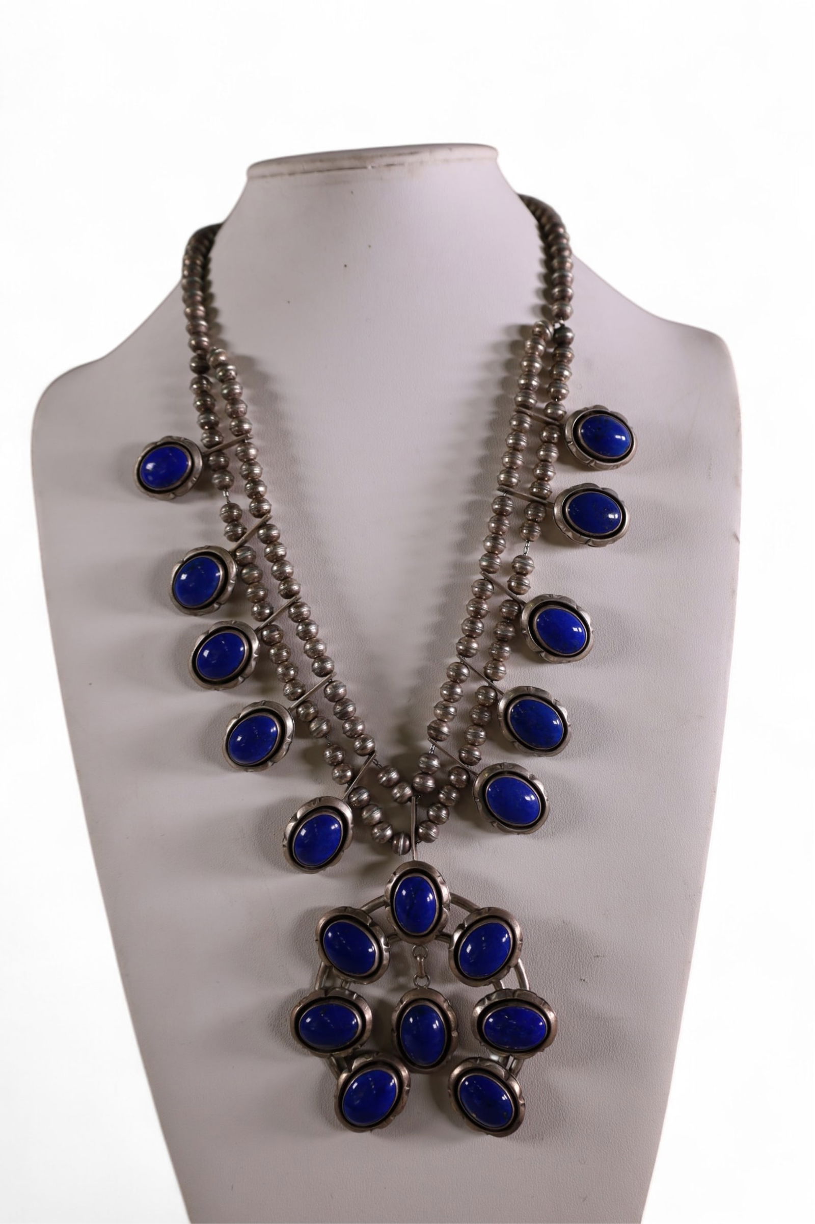 STERLING SILVER & LAPIS SQUASH BLOSSOM: HANDMADE NATIVE AMERICAN STERLING SIVLER AND LAPIS SQUASH BLOSSOM NECKLACE. MARKED W. JOHNSON. (WILLIAM T. JOHNSON) MARKED STERLING. 16" L. APPROX 211 GRAMS TOTAL WEIGHT.