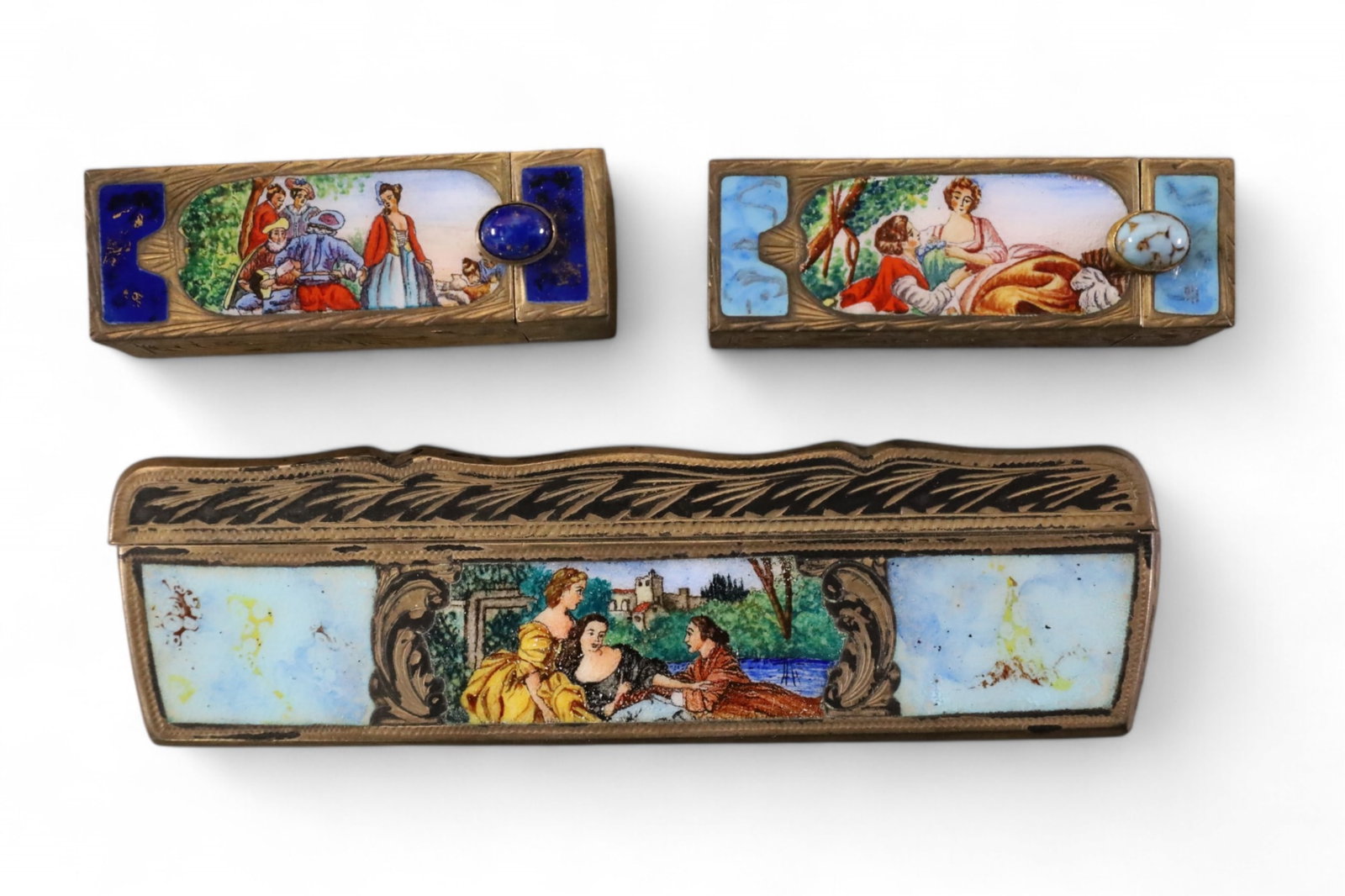 3 PIECES OF ENAMELWARE: 2 LIPSTICK HOLDERS & COMB. SCENIC ENAMEL DECORATED.