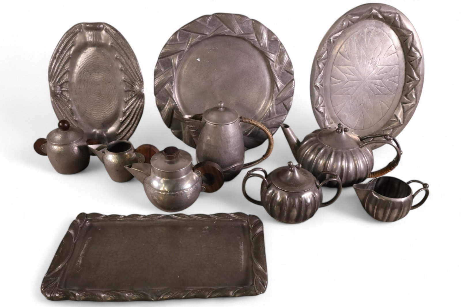 COLLECTION OF ART NOUVEAU PEWTER: TRAYS, PITCHERS, CUPS, CREAMERS, AND MORE.