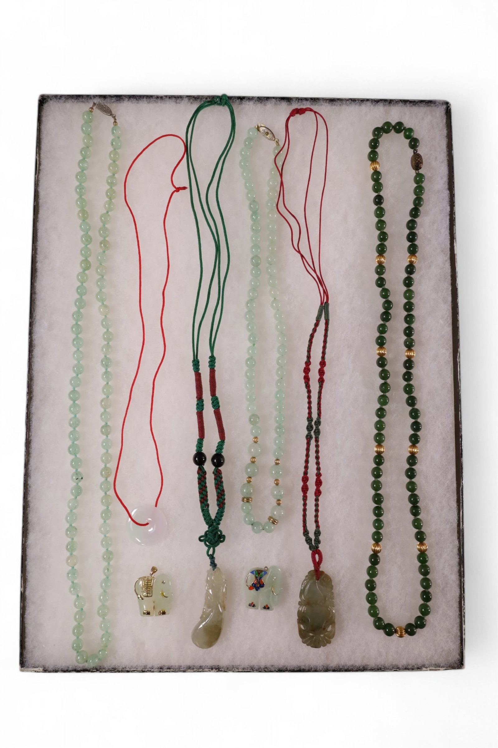 GROUPING OF JADE & STONE JEWELRY: BEADED JADE NECKLACES, LOOSE JADE ELEPHANT PENDANTS, & JADE PENDANTS ON STING NECKLACES.