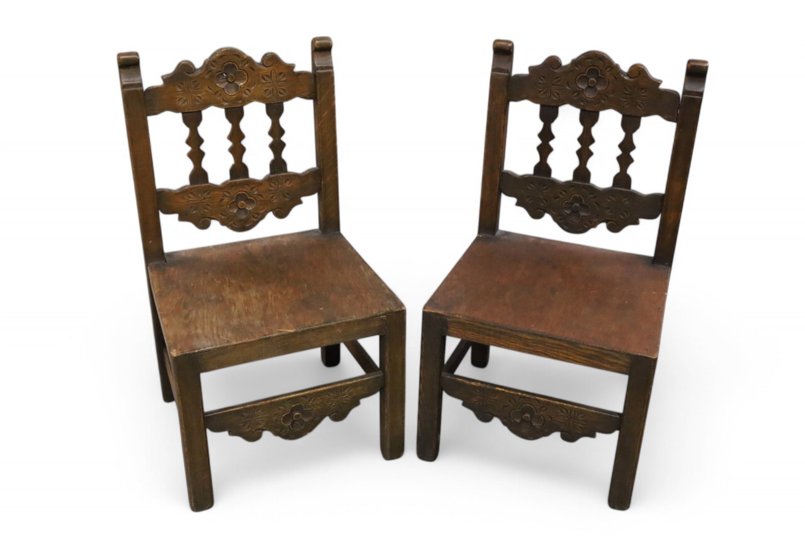PAIR OF SPANISH CHILD'S CHAIRS: PAIR OF CARVED SPANISH CHILD'S CHAIRS, MINOR WEAR TO FINISH. 15" W x 14" D x 28" H. THIS ITEM EXCEEDS SIZE LIMITATIONS FOR IN HOUSE SHIPPING, MUST BE PICKED UP IN HOUSE OR SHIPPED VIA 3rd PARTY SHIPPE