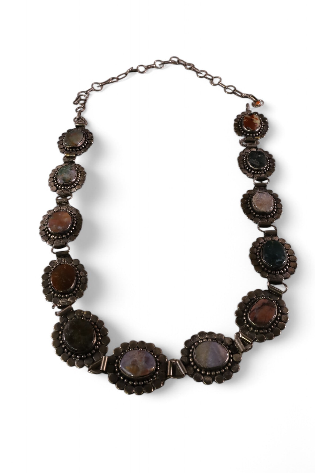 SILVER CONCHO BELT: 12 MEDALLION CONCHO BELT, POSSIBLY AGATE MEDALLIONS. ONE CONNECTER HAS BEEN REPLACED. 47" L.