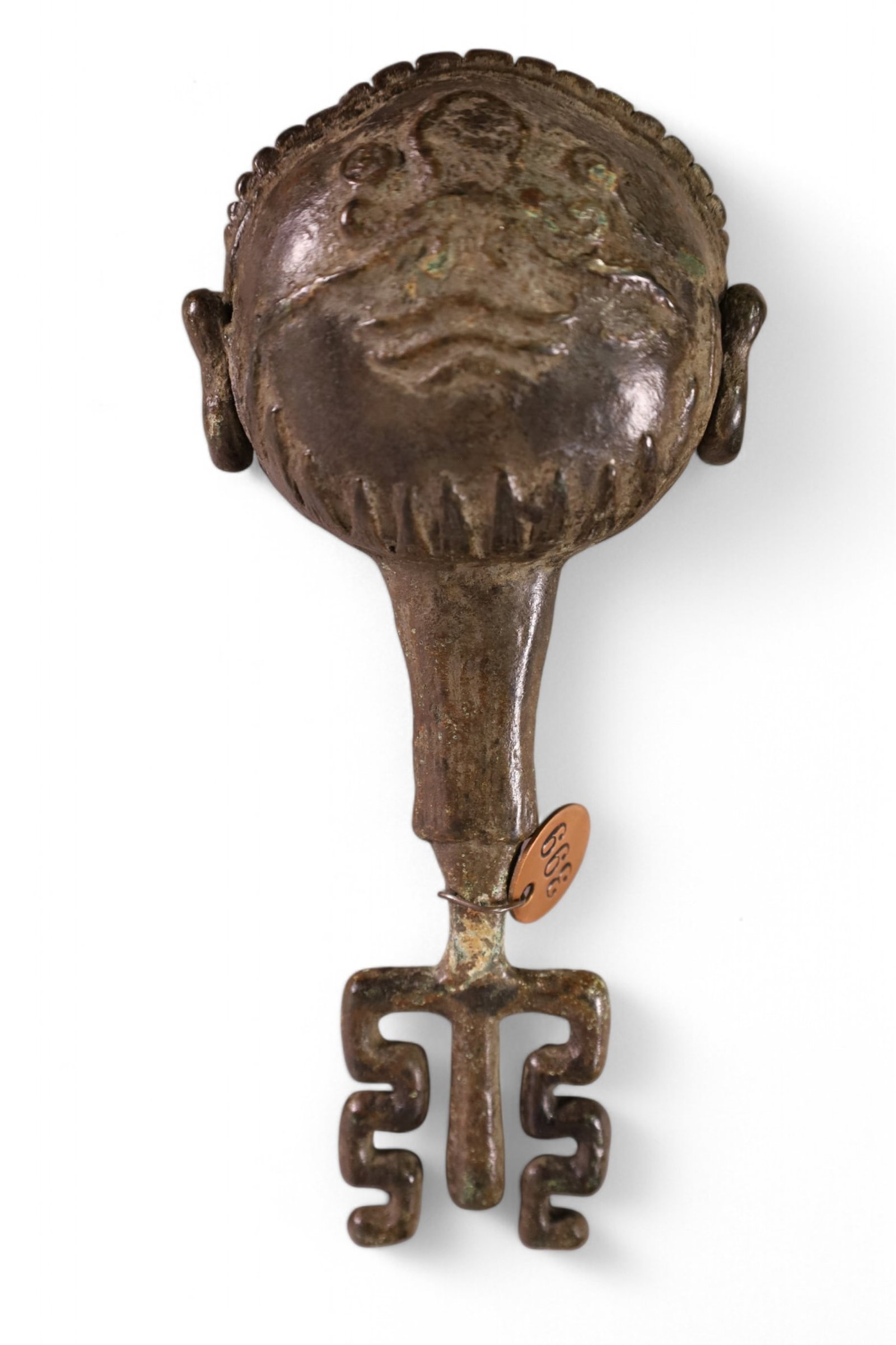 FLATTENED FROG MOUTHED WANAGUCHI RATTLE: BODY OF RATTLE HAS THE EYES, EARS, NOSE, AND SLIT MOUTH OF FROG. DUG UP FROM AN OLD MONUMENT IN A TEMPLE CEMETERY AT KYOTO JAPAN. HAS METAL TAG 399 FROM MISSION INN RIVERSIDE CALIFORNIA. 8" LONG X 3" 