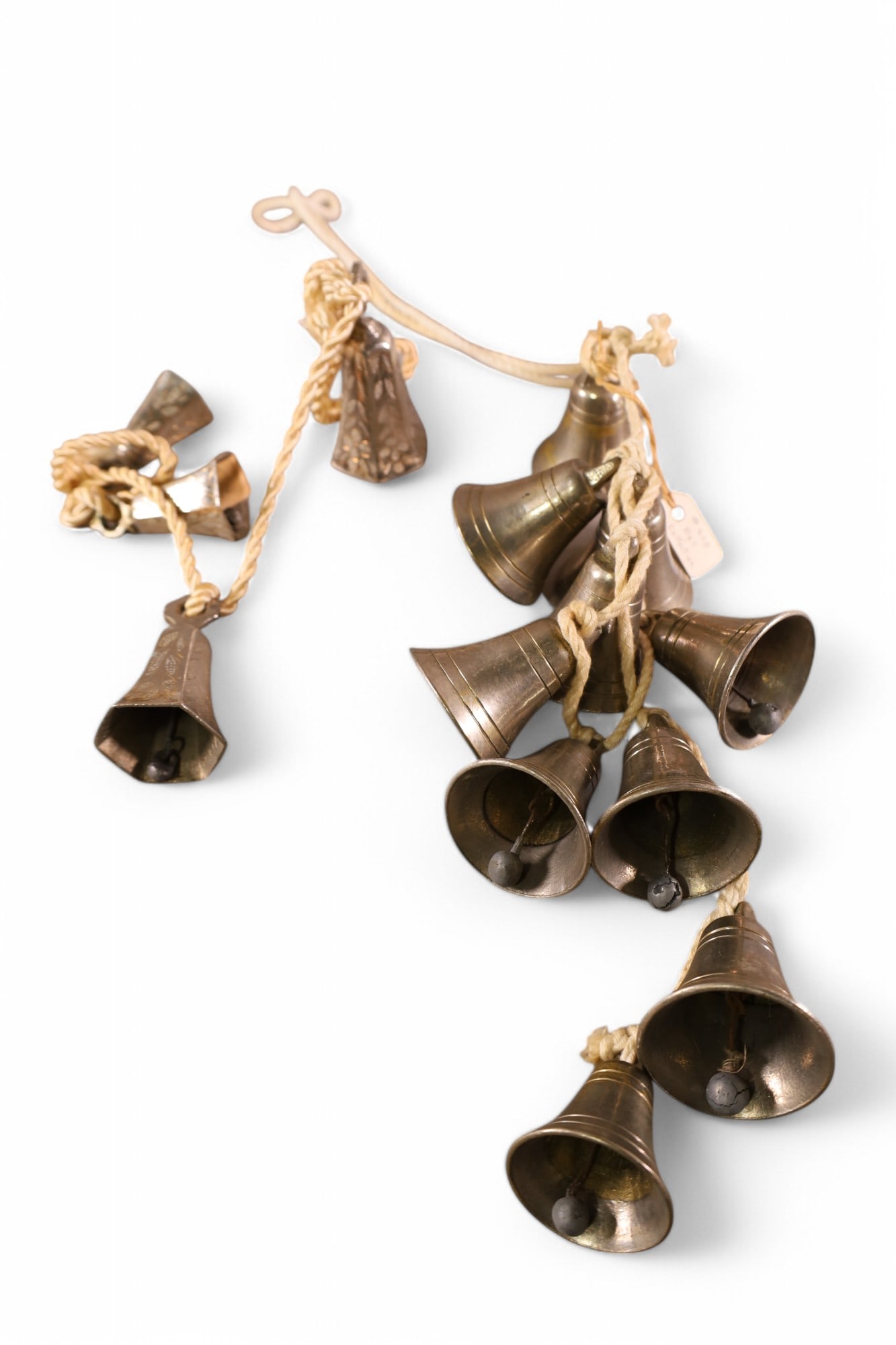 2 STRINGS OF BELLS: STRING WITH 10 POLISHED BELLS ON ROPE, & GRADUATED STRING OF 4 BELLS ON ROPE.