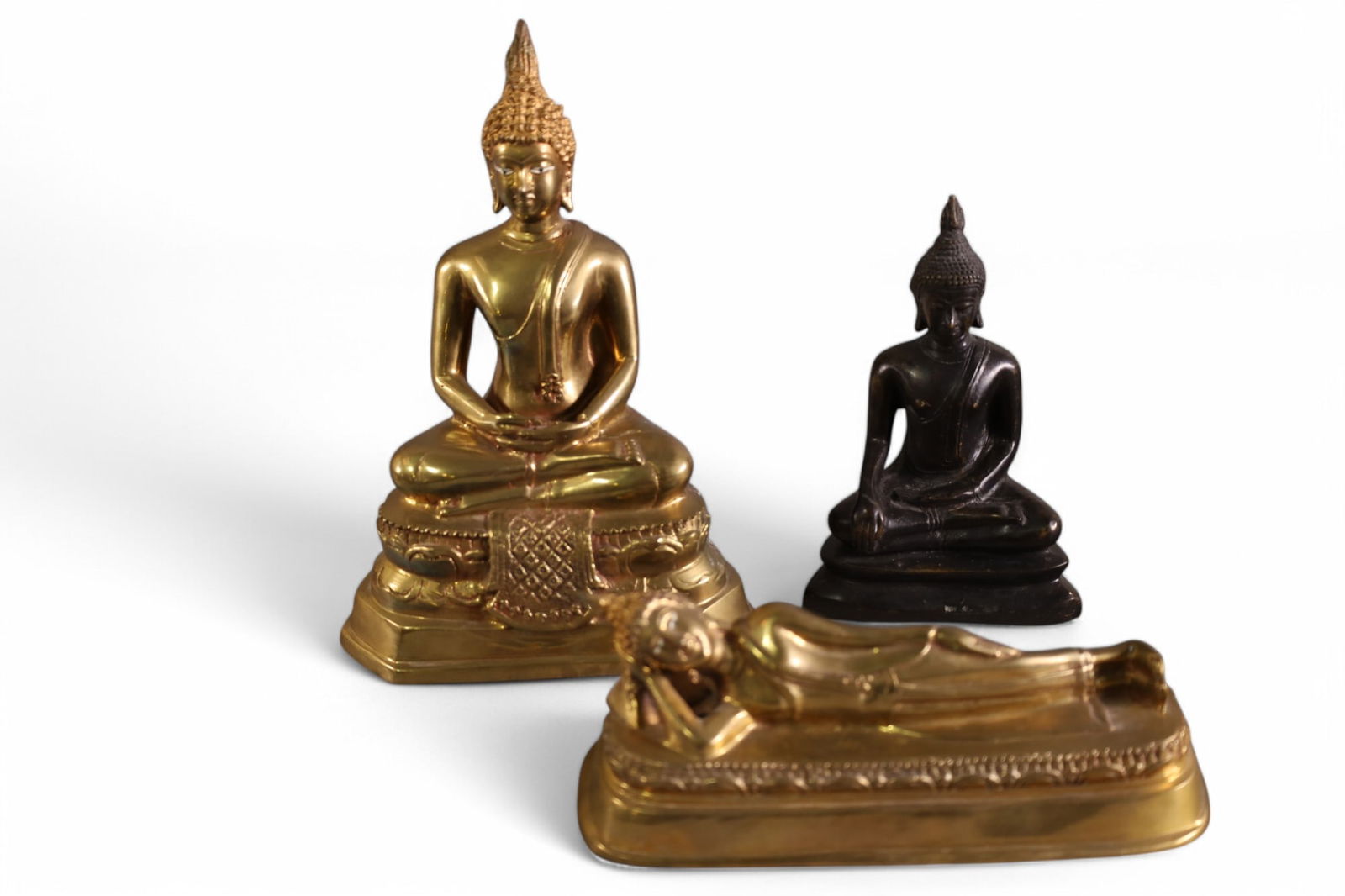 3 BUDDHA FIGURES: 3 METAL BUDDHA FIGURES, 2 SEATED, 1 RECLINING. 8" L & 9" H.