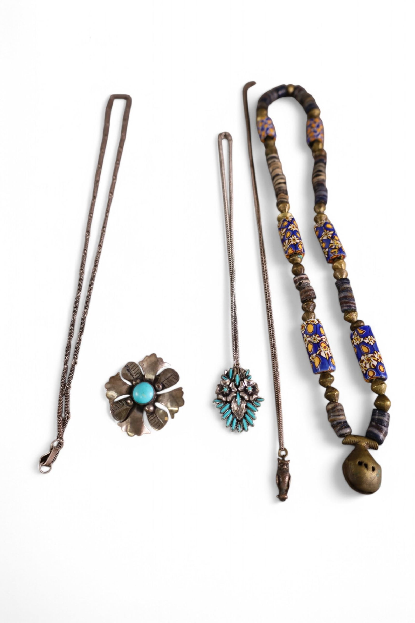 5 PIECES OF NATIVE AMERICAN JEWELRY: BEADED RATTLE NECKLACE, TURQUIOSE PENDANDT ON CHAIN, SILVE & TURQUOISE PIN, & 2 SILVER CHAINS.