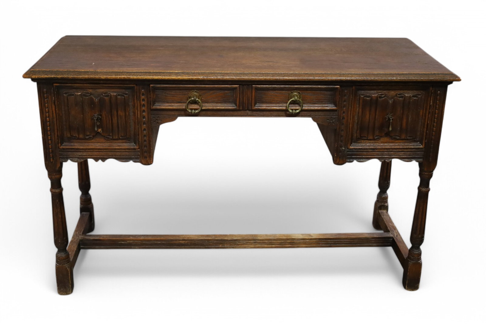 1920'S SPANISH STYLE DESK: 3 DRAWER SPANISH STYLE DESK, WEAR TO FINISH. 50" W x 20" D x 30" H. THIS ITEM EXCEEDS SIZE LIMITATIONS FOR IN HOUSE SHIPPING, MUST BE PICKED UP IN HOUSE OR SHIPPED VIA A 3RD PARTY SHIPPER.
