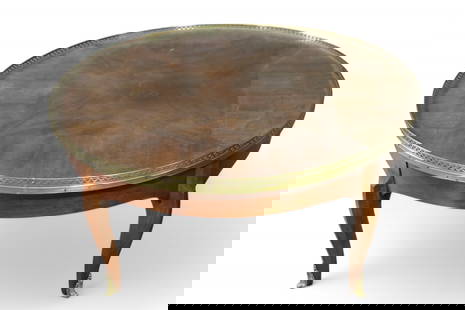 BAKER FURNITURE FRENCH STYLE COFFEE TABLE: FRENCH STYLE GLASS TOP COFFEE TABLE, BRASS GALLERY. 36" DIAM x 17" H. THIS ITEM EXCEEDS SIZE LIMITATIONS FOR IN HOUSE SHIPPING, MUST BE PICKED UP IN HOUSE OR SHIPPED VIA 3rd PARTY GROUND SHIPPER.