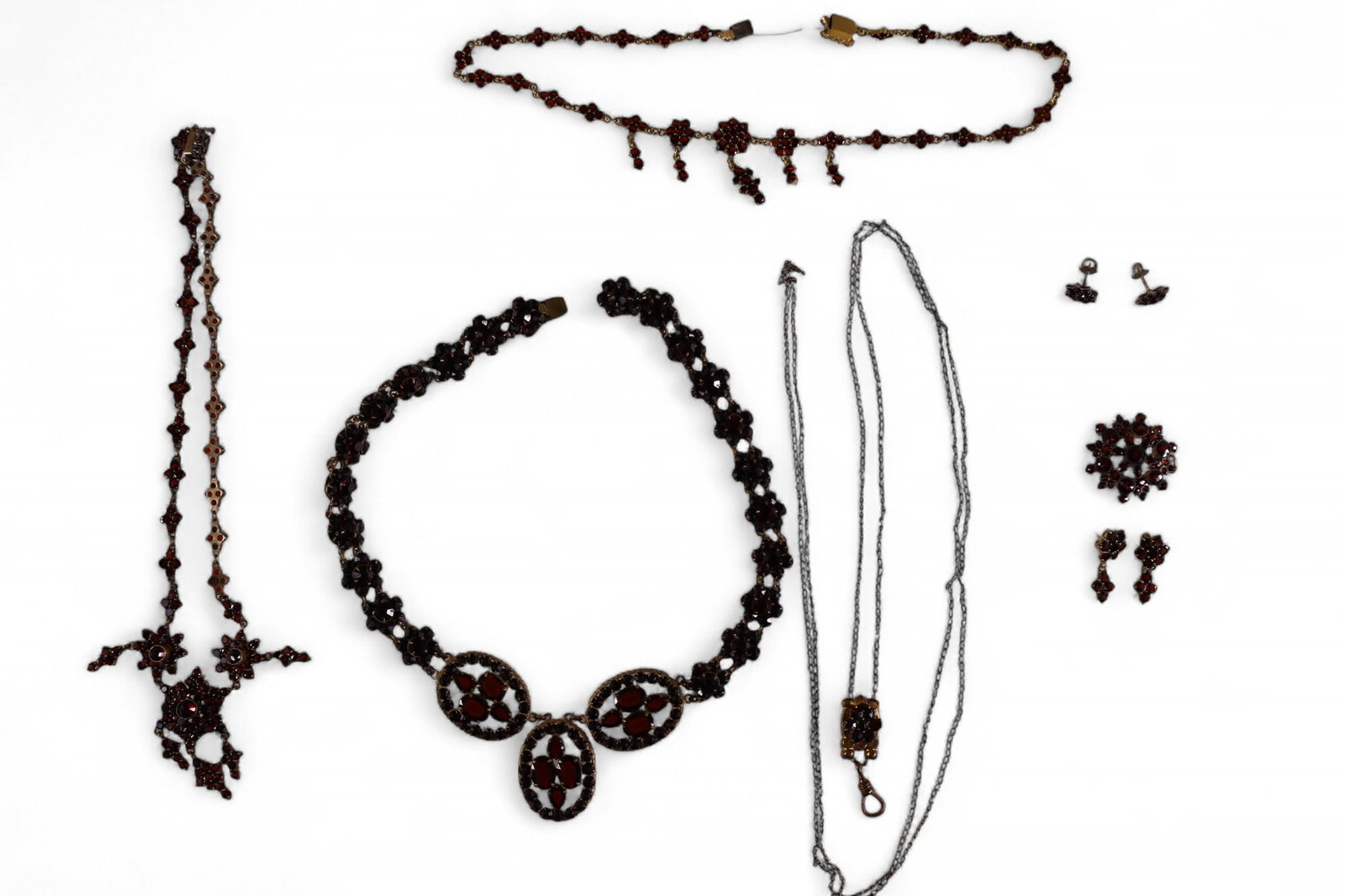GROUPING OF GARNET JEWELRY: INCLUDING SLIDE NECKLACE, PR. EARRINGS, PENDANT, NECKLACES, AND MORE. SHOWCASE NOT INCLUDED.