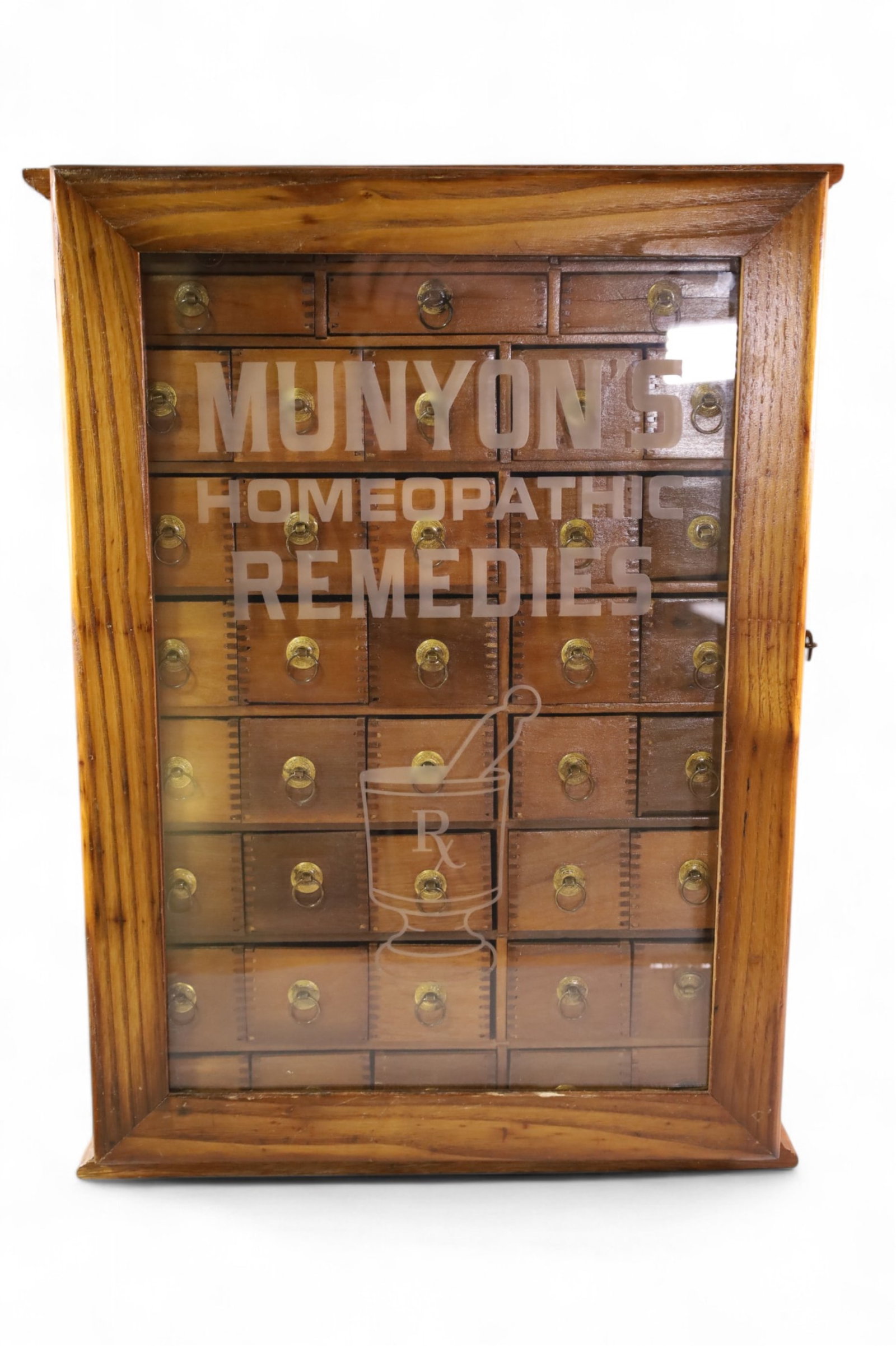 MUNYON'S HOMEOPATHIC REMEDIES CABINET: SINGLE DOOR DISPLAY CABINET, MUNYONS HOMEOPATHIC REMEDIES CABINET, WITH TIN SIGN ON REVERSE. 18" W x 7" D x 24" H. THIS ITEM EXCEEDS SIZE OR WEIGHT LIMITATIONS FOR IN HOUSE SHIPPING, MUST BE PICKED UP