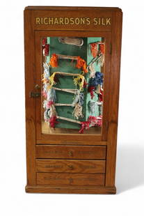 RICHARDSONS SILK STORE DISPLAY CABINET: GENERAL STORE RICHARDSONS SILK DISPLAY CABINET, LOWER DRAWERS. SOME PAINT LOSS AND WEAR. REVOLVING CENTER DISPLAY. 16" W x 16" D x 33" H. THIS ITEM EXCEEDS SIZE OR WEIGHT LIMITATIONS FOR IN HOUSE SHIP
