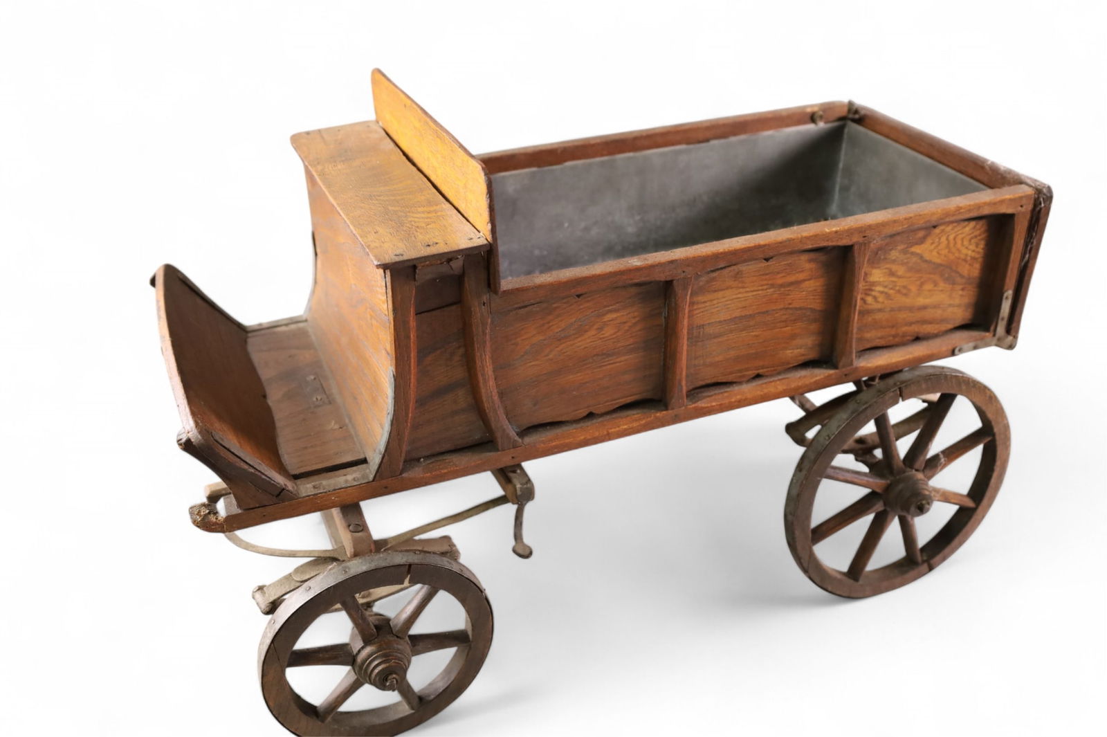 CHILD'S WAGON: ANTIQUE OAK CHILD'S WAGON WITH GALVANIZED LINER. 23" L x 10"W . THIS ITEM EXCEEDS SIZE OR WEIGHT LIMITATIONS FOR IN HOUSE SHIPPING, MUST BE PICKED UP IN HOUSE OR SHIPPED VIA 3rd PARTY SHIPPER.