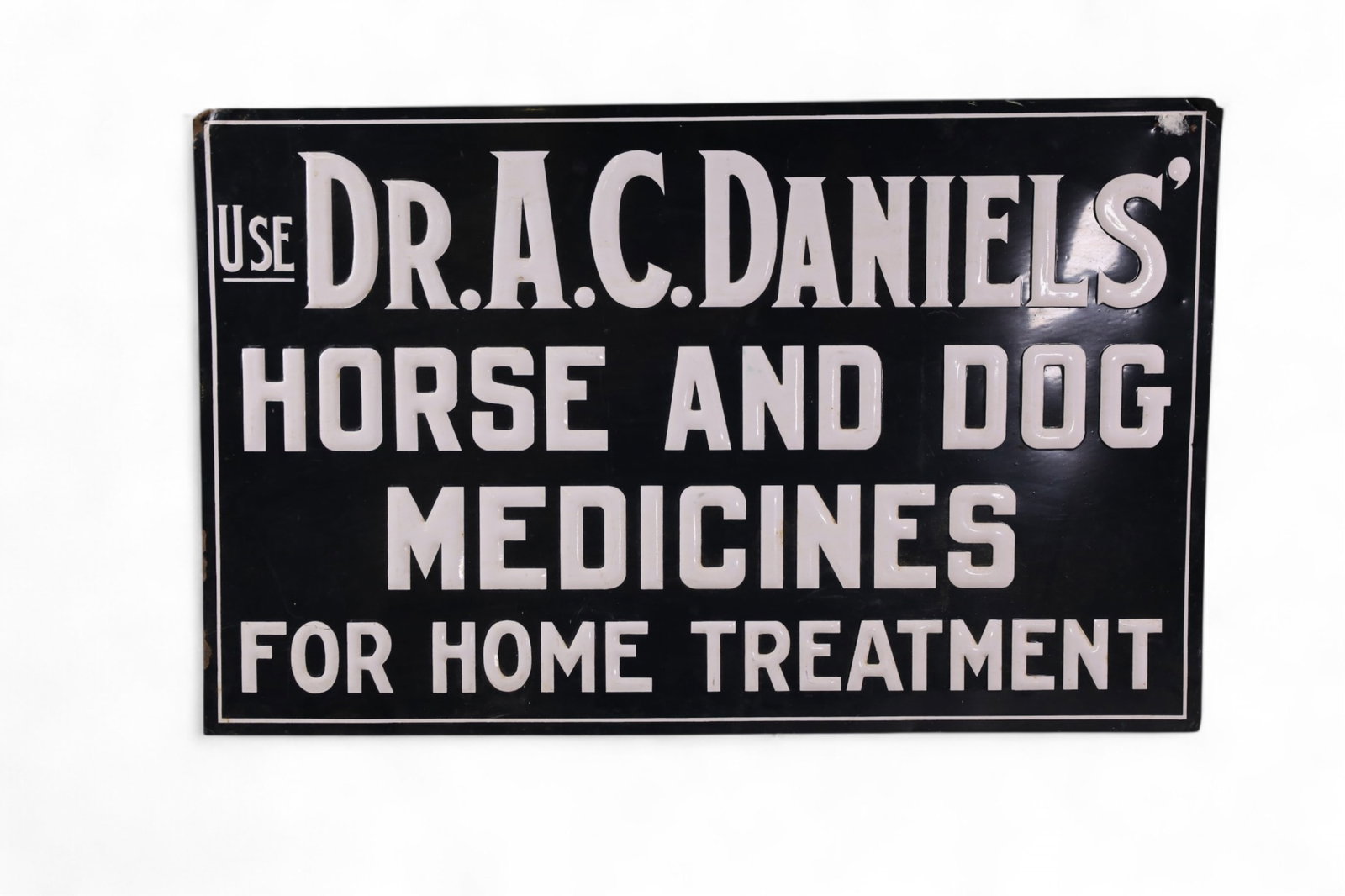 DR DANIELS' VET TIN SIGN: DR DANIELS' HORSE AND DOG MEDICINES PAINTED TIN EMBOSSED SIGN, PAINT LOSS ALONG EDGES. 28" x 17 1/2"