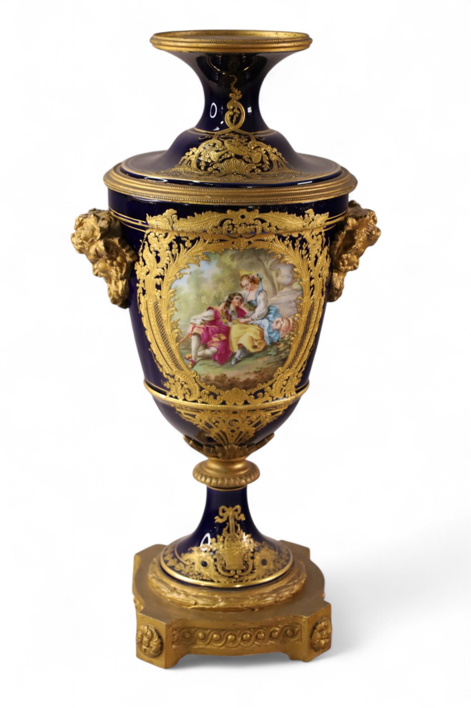 SEVRES STYLE PORCELAIN URN: LARGE SEVRES STYLE PORCELAIN URN WITH GOLD ENAMEL DECORATION. HAND PAINTED SCENIC FRONT. 18" H.