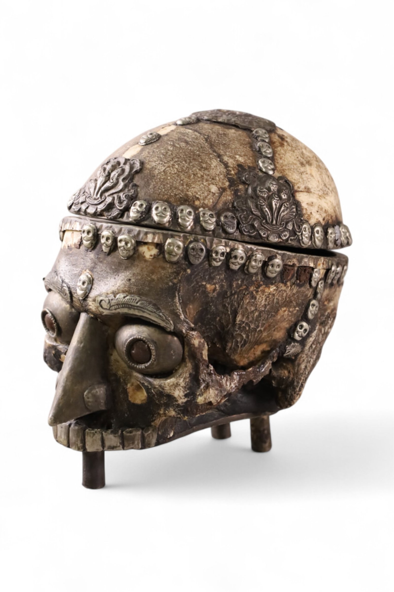 TIBETAN RITUAL SKULL CUP: TABLE TOP KAPALA TIBETAN RITUAL SKULL CUP. MISSING SOME DECORATION. 8" L x 7 1/2" H.