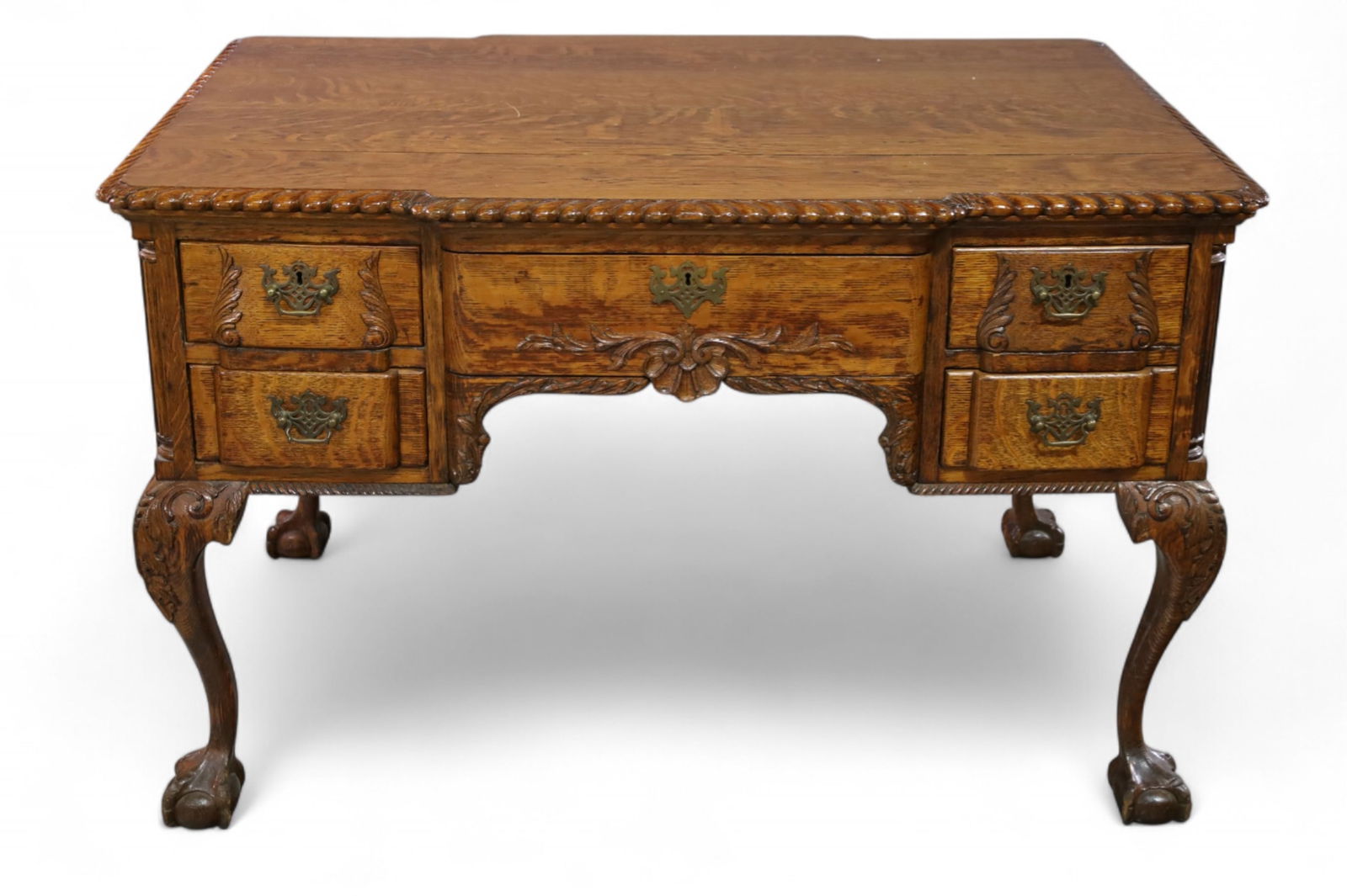 FANCY AMERICAN OAK PARTNERS DESK: LARGE AMERICAN OAK DESK, CARVED SKIRT, LARGE BALL AND CLAW FOOT. FAUX DRAWERS ON ONE SIDE. MISSION 1 PULL. 48" W x 34" D x 31" H. THIS ITEM EXCEEDS SIZE LIMITATIONS FOR IN HOUSE SHIPPING, MUST BE PICK