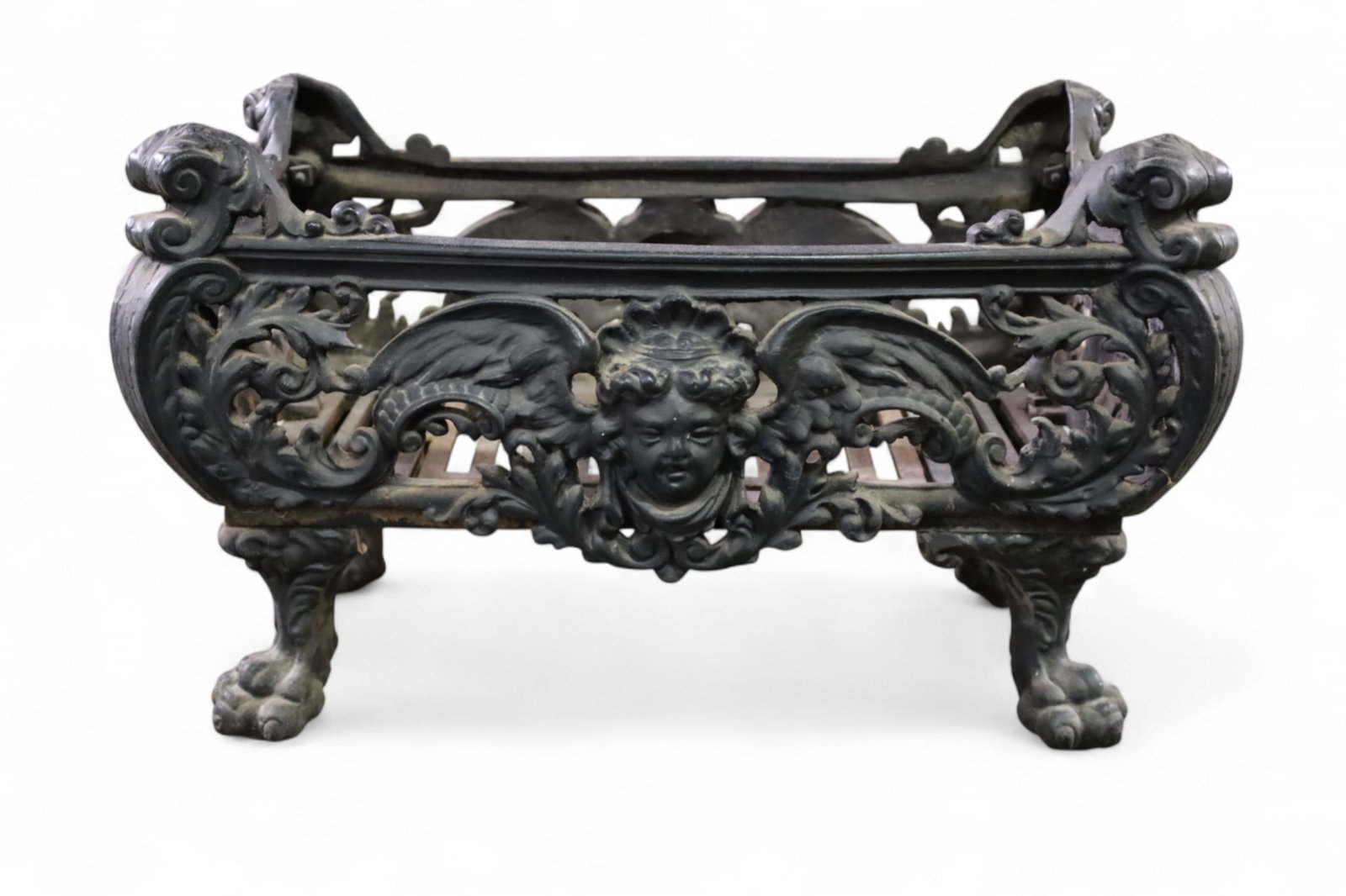 VICTORIAN CAST IRON LOG HOLDER: VICTORIAN CAST IRON LOG HOLDER, CHERUB AND CLAW FOOT DECORATION. 23" L x 14" D x 14" H. THIS ITEM EXCEEDS SIZE LIMITATIONS FOR IN HOUSE SHIPPING, MUST BE PICKED UP IN HOUSE OR SHIPPED VIA 3rd PARTY GR