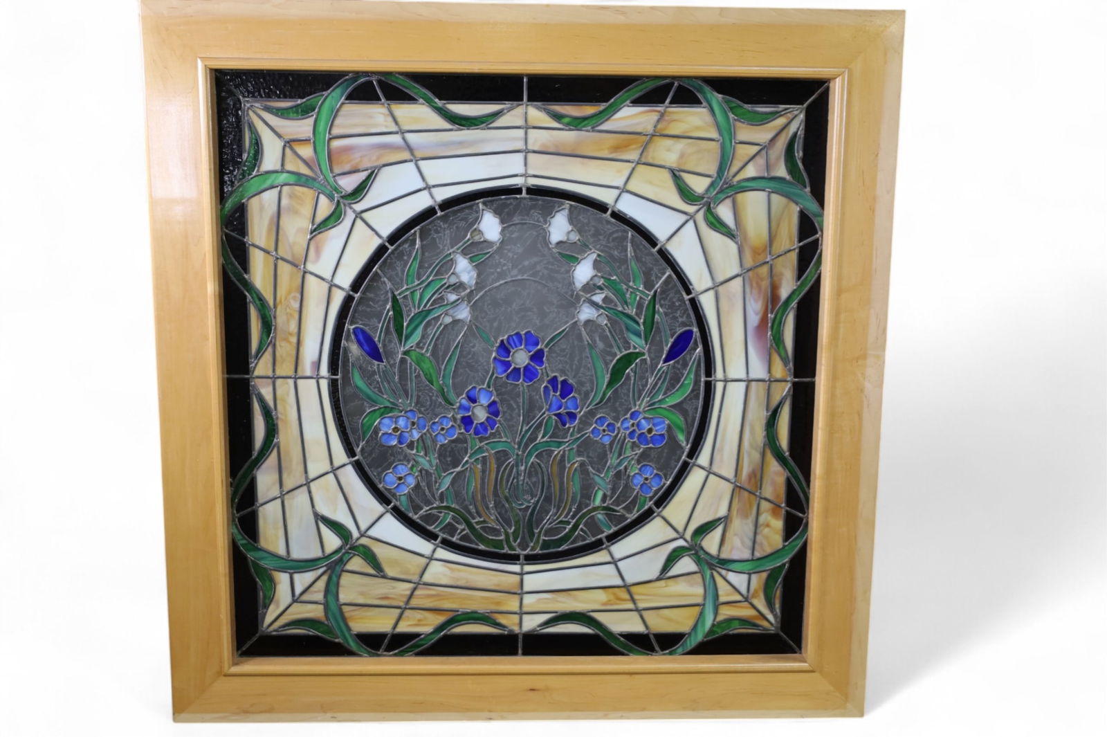 LARGE LEADED GLASS WINDOW: LARGE STAINED GLASS WINDOW IN CONTEMPORARY WOODEN FRAME, MINOR CRACKS TO PANELS. 52" W x 52" IN FRAME. THIS ITEM EXCEEDS SIZE LIMITATIONS FOR IN HOUSE SHIPPING, MUST BE PICKED UP IN HOUSE OR SHIPPED V