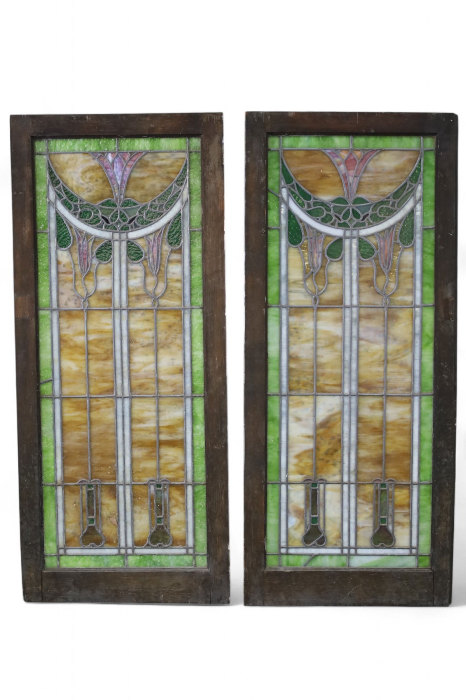 2 ARTS & CRAFTS STAINED GLASS WINDOWS: LARGE ARTS & CRAFTS LEADED GLASS WINDOWS, IN WOODEN FRAMES. SOME CRACKED PANELS. 21 1/2" W x 51" H. THIS ITEM EXCEEDS SIZE LIMITATIONS FOR IN HOUSE SHIPPING, MUST BE PICKED UP IN HOUSE OR SHIPPED VIA
