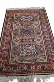 APPROX 6' 8" x 4' 6" HANDMADE WOOL RUG