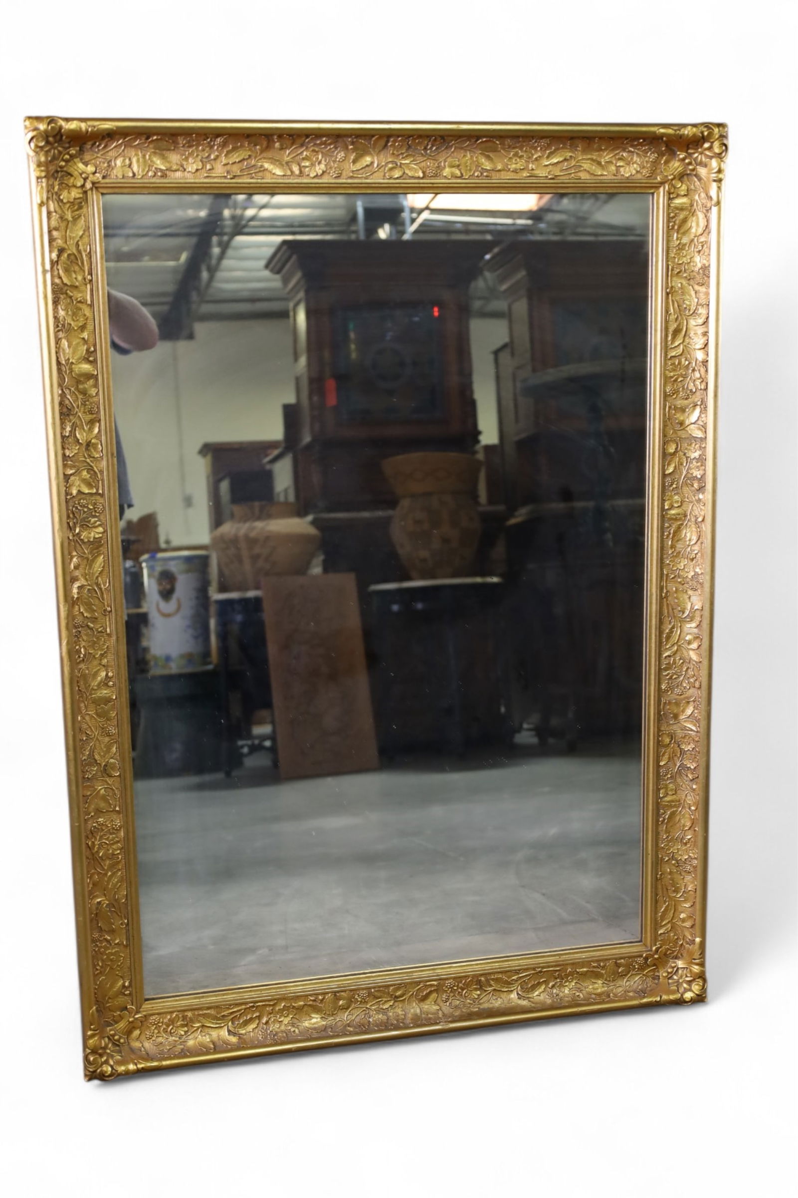 GOLD GILT WALL MIRROR: FLORAL DECROATED GOLD GILT WALL MIRROR. 31 1/2" W x 44" H. THIS ITEM EXCEEDS SIZE LIMITATIONS FOR IN HOUSE SHIPPING, MUST BE PICKED UP IN HOUSE OR SHIPPED VIA 3rd PARTY GROUND SHIPPER.