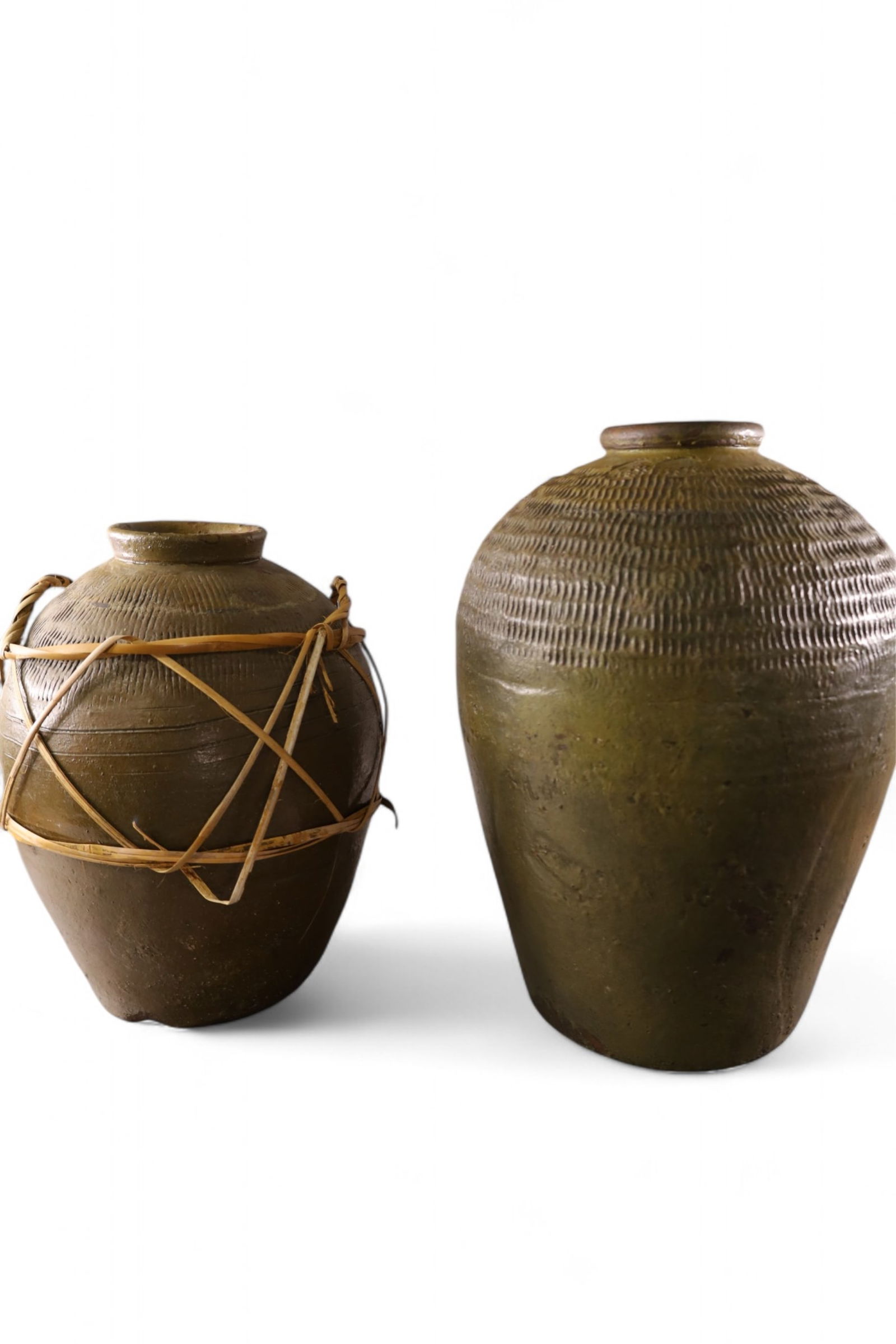 TWO POTTERY WINE JARS: 2 LARGE POTTERY WINE JARS, ONE WITH WRAPPED HANDLES. 21" & 17" H.