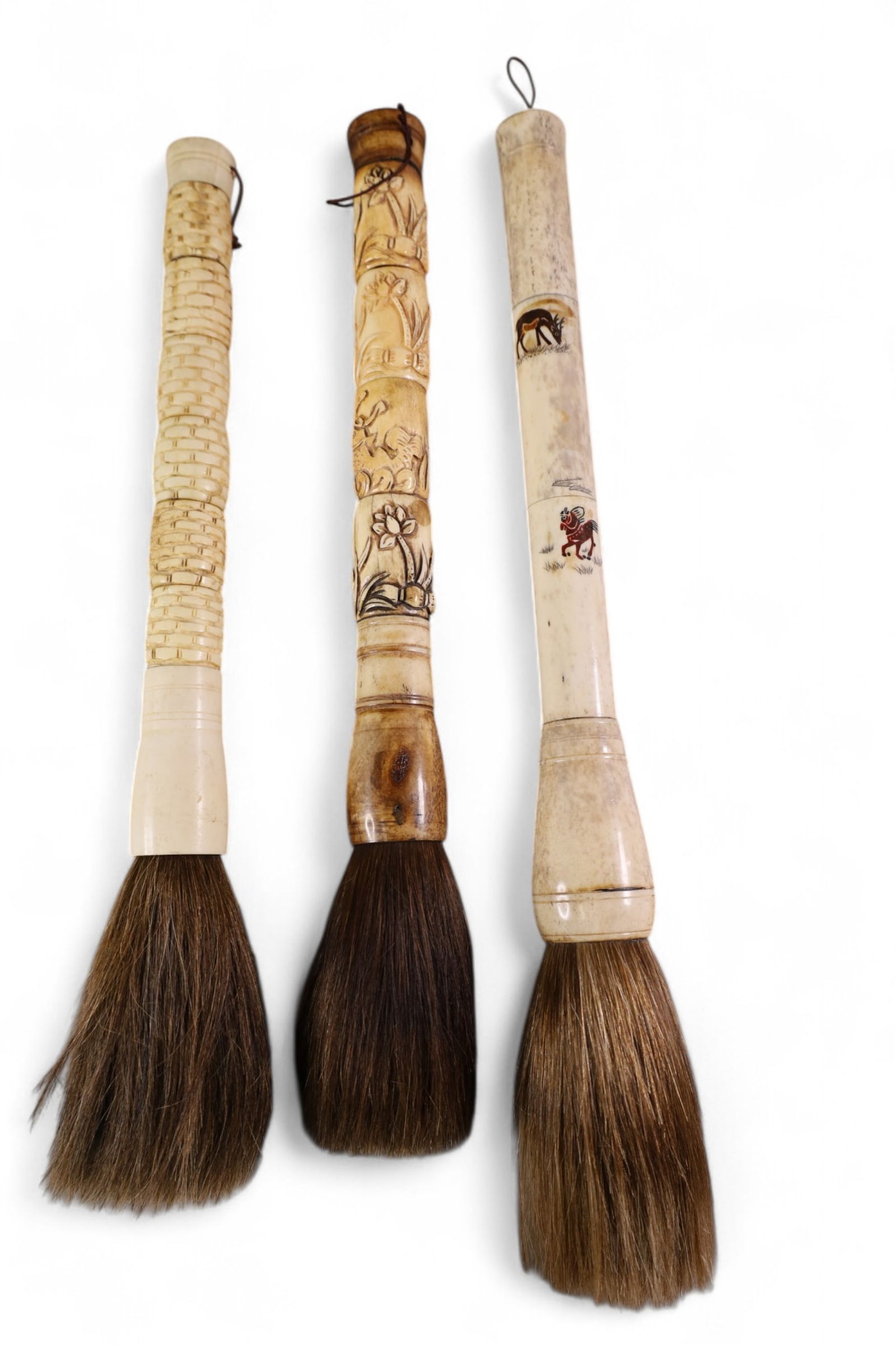 3 CARVED CALLIGRAPHY BRUSHES: 3 CARVED BONE HANDLED CALLIGRAPHY BRUSHES. HORSE HAIR. 17" - 18 1/2" L