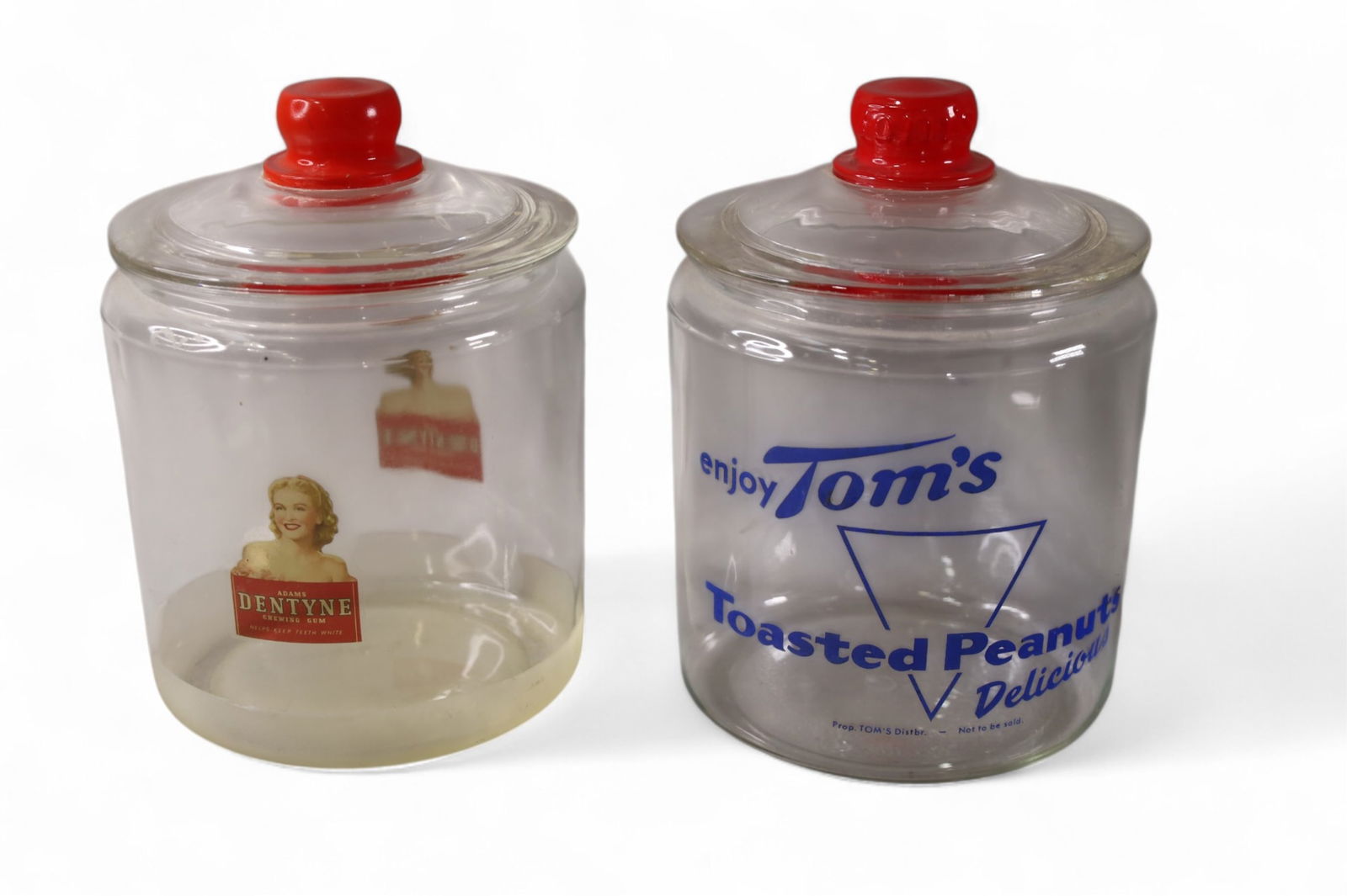 2 ADVERTISING GLASS JARS: LIDDED GLASS JARS, DENTYNE & TOMS. 10" H.