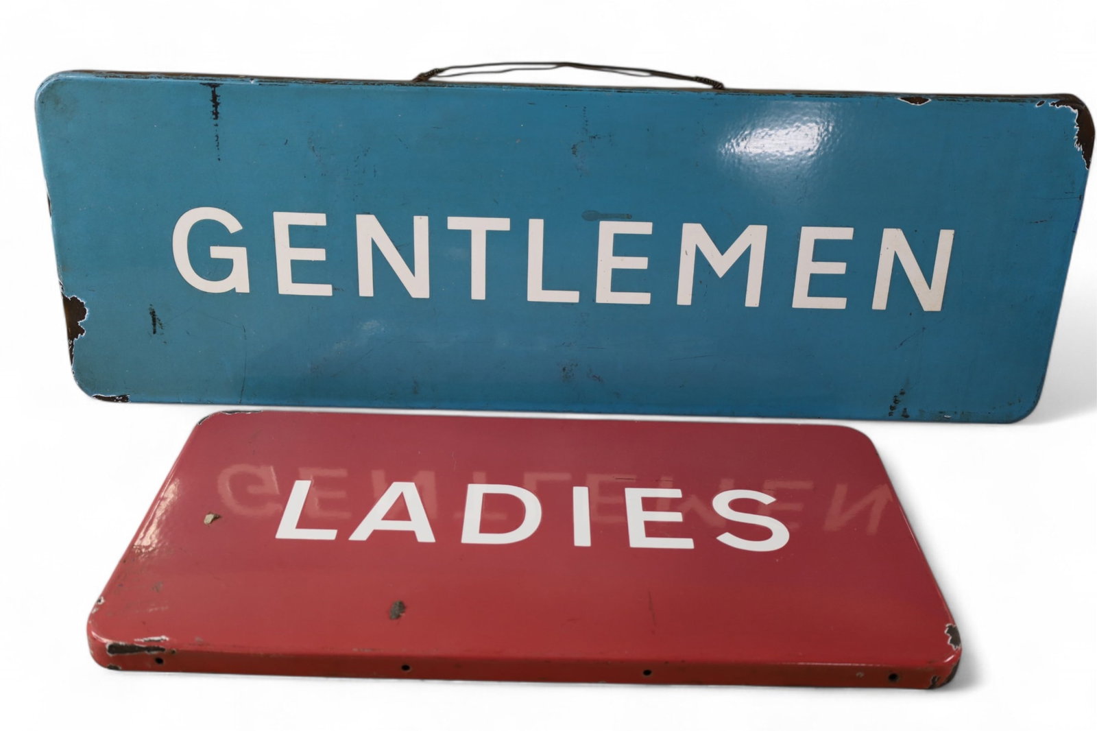 2 RESTROOM SIGNS: SINGLE SIDED PORCELAIN, GENTLEMEN & LADIES. CHIPS. 36" x 12" & 24" x 12"