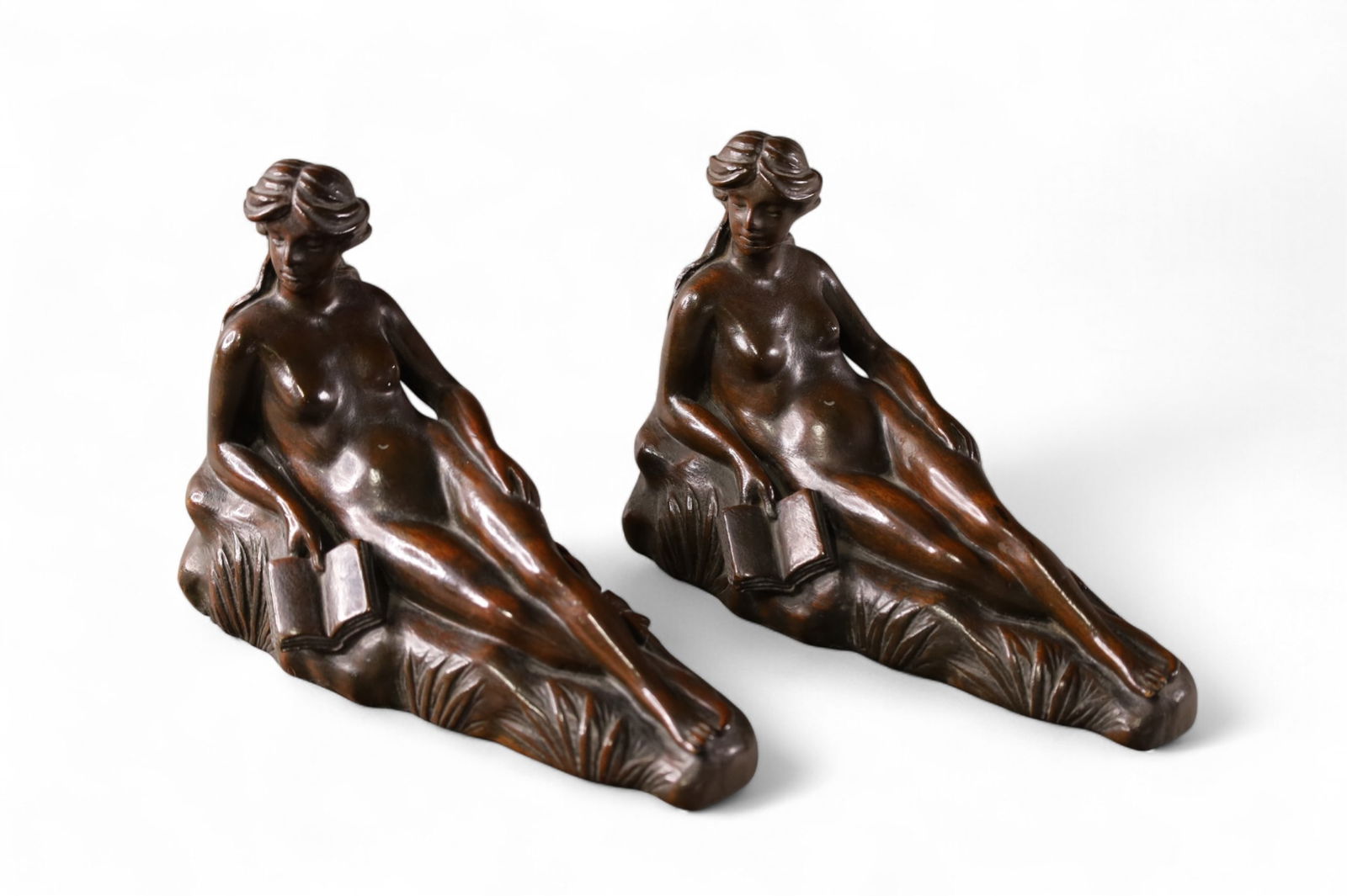 PAIR OF NUDE BOOKENDS: PAIR OF CARVED WOODEN NUDE FIGURAL BOOKENDS. RECLINING NUDE. 9" L.