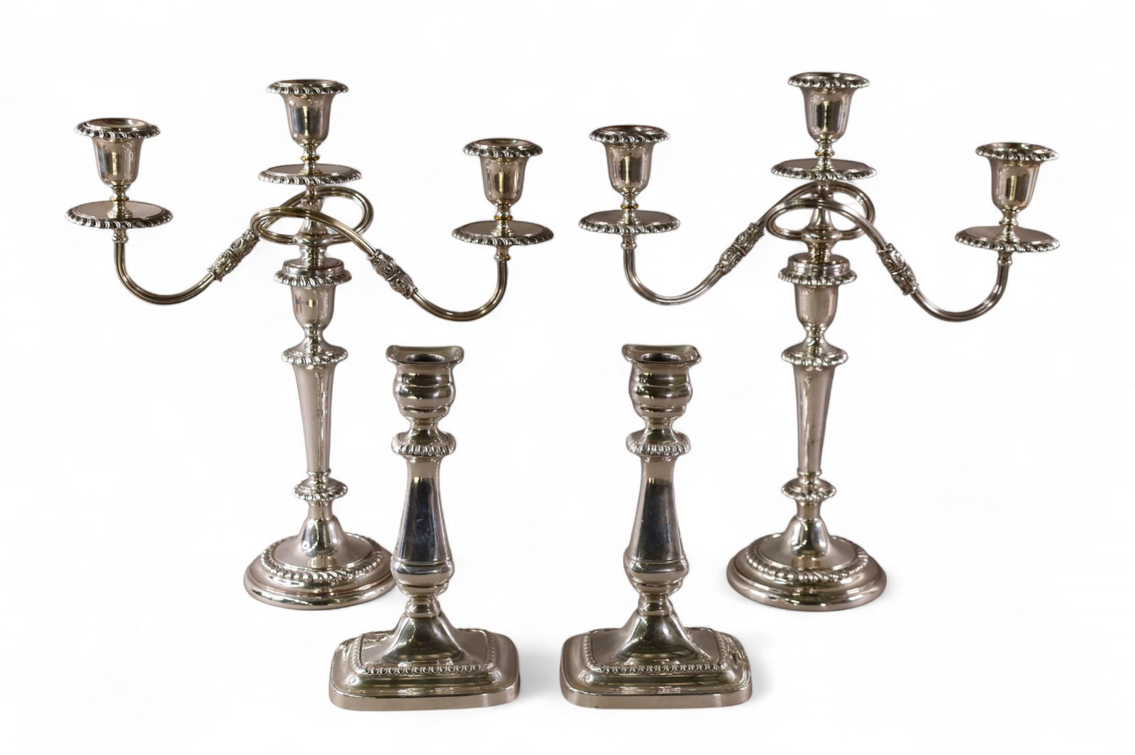 SILVERPLATED CANDLESTICKS: 2 PAIRS OF SILVERPLATED CANDLESTICKS. 9 1/2" - 16" H.