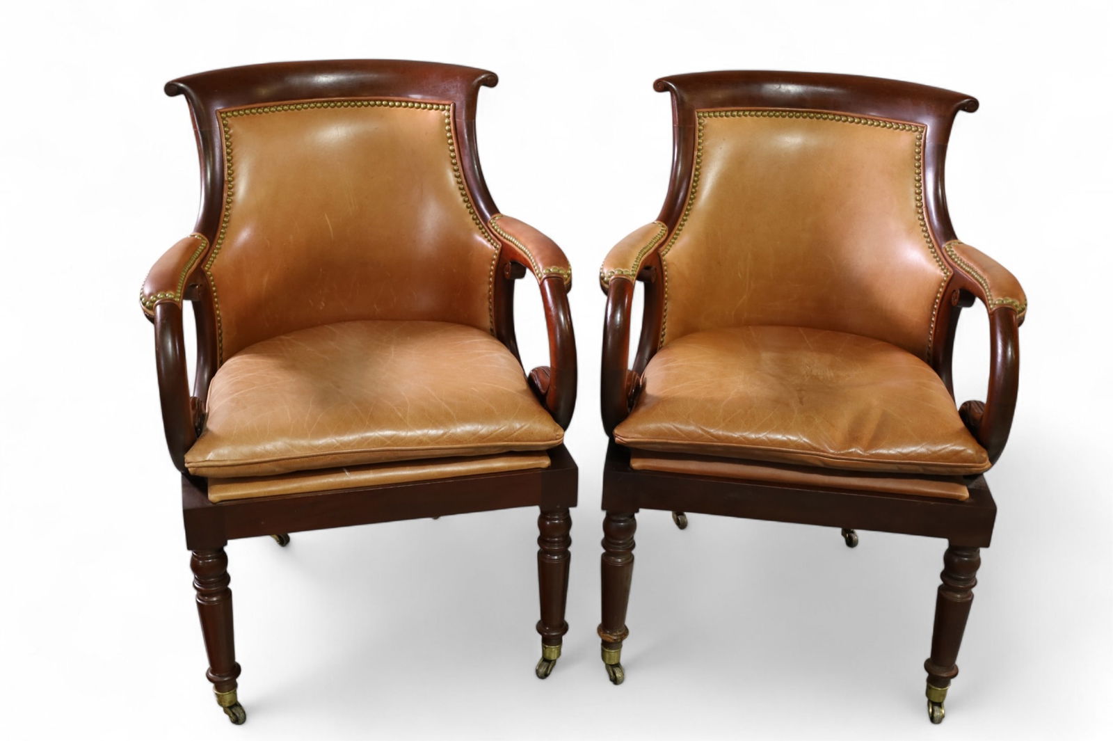 PAIR OF LEATHER ARMCHAIRS: HANCOCK & MOORE MAHOGANY AND LEATHER ARMCHAIRS, BRASS TACKED. ON CASTERS. SOME WEAR TO FINISH. 24" W x 26" D x 34" H. THIS ITEM EXCEEDS SIZE LIMITATIONS FOR IN HOUSE SHIPPING, MUST BE PICKED UP IN HOU