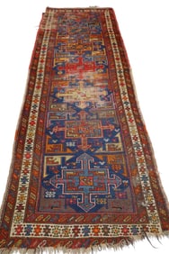 APPROX 9' 6" x 3' 4" HANDMADE WOOL RUG